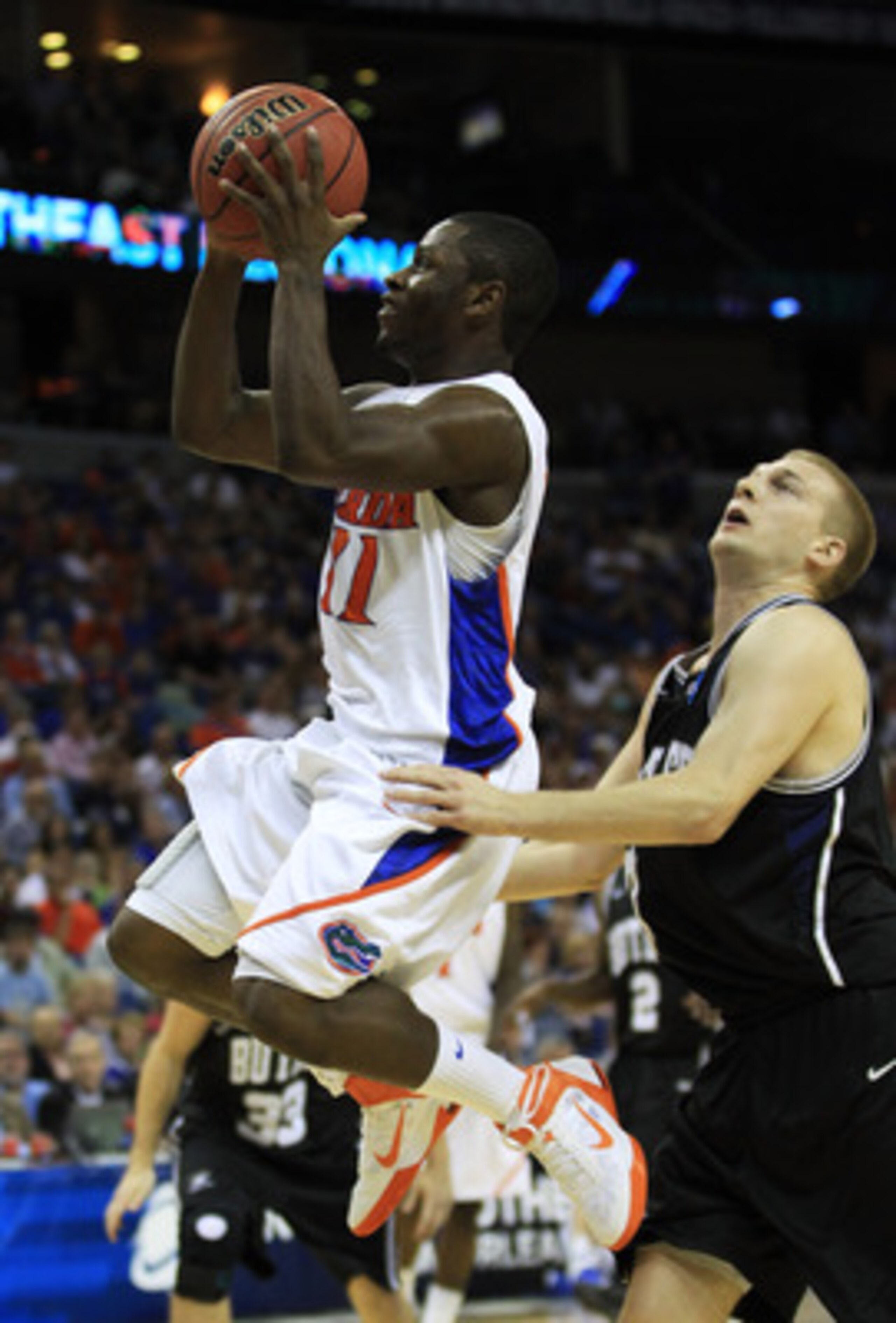 NEW ORLEANS, LA - MARCH 26:  Erving Walker #11 of the Florida Gators shoots past Zach Hahn #3 of the Butler Bulldogs in the first half during the Southeast regional final of the 2011 NCAA men's basketball tournament at New Orleans Arena on March 26, 2011