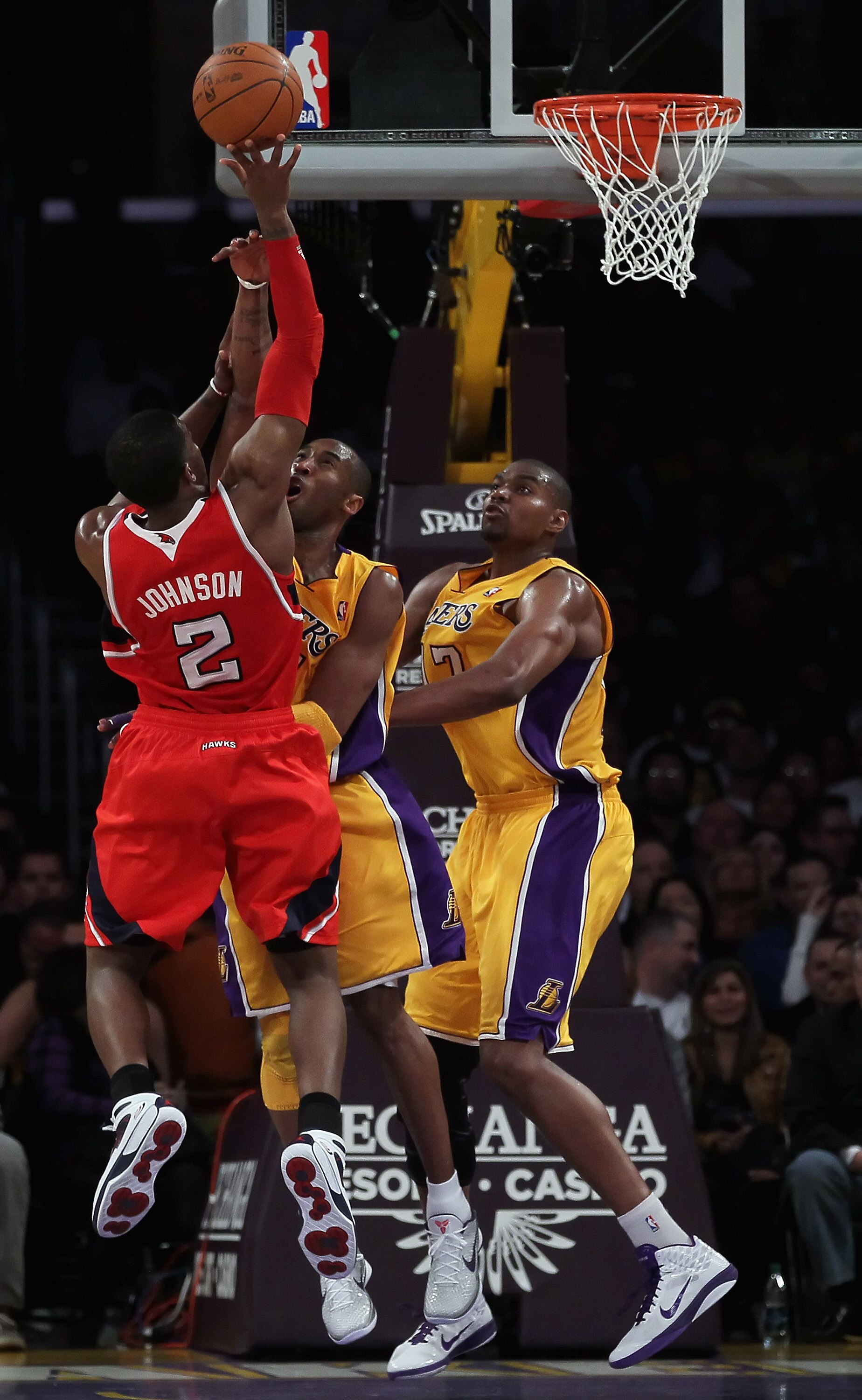 LOS ANGELES, CA - FEBRUARY 22:  (L-R) Joe Johnson #2 of the Atlanta Hawks shoots while being defended by Kobe Bryant #24 and Andrew Bynum #17 of the Los Angeles Lakers in the first half at Staples Center on February 22, 2011 in Los Angeles, California. Th