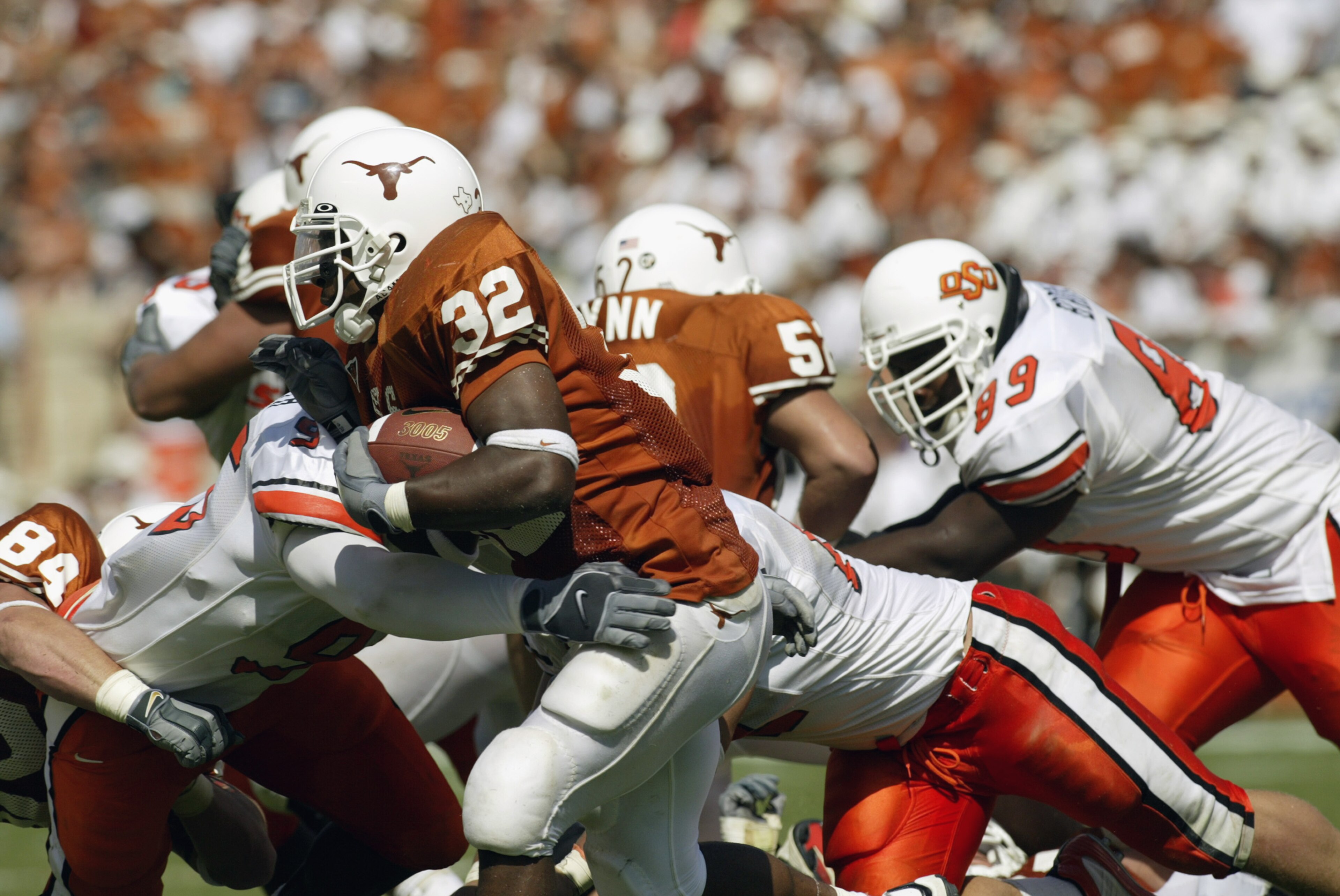 AUSTIN, TX - OCTOBER 5:  Running back Cedric Benson #32 of the Texas Longhorns runs with the ball during the Big 12 Conference football game against the Oklahoma State Cowboys on October 5, 2002 at Darrell K Royal-Texas Memorial Stadium in Austin, Texas.