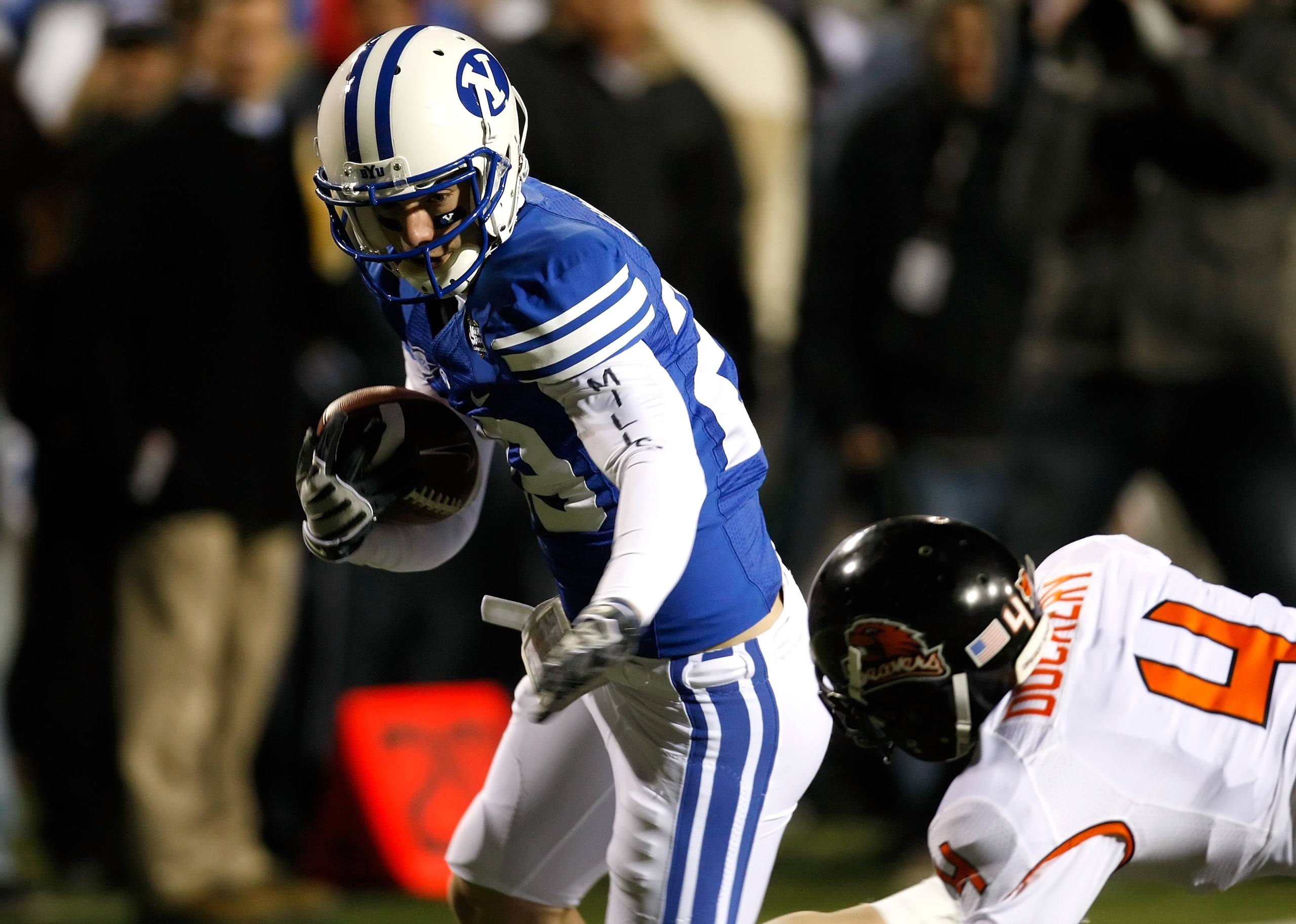 LAS VEGAS - DECEMBER 22:  Luke Ashworth #29 of the Brigham Young University Cougars gets away from James Dockery #4 of the Oregon State Beavers to score a touchdown in the second quarter of the MAACO Las Vegas Bowl at Sam Boyd Stadium December 22, 2009 in