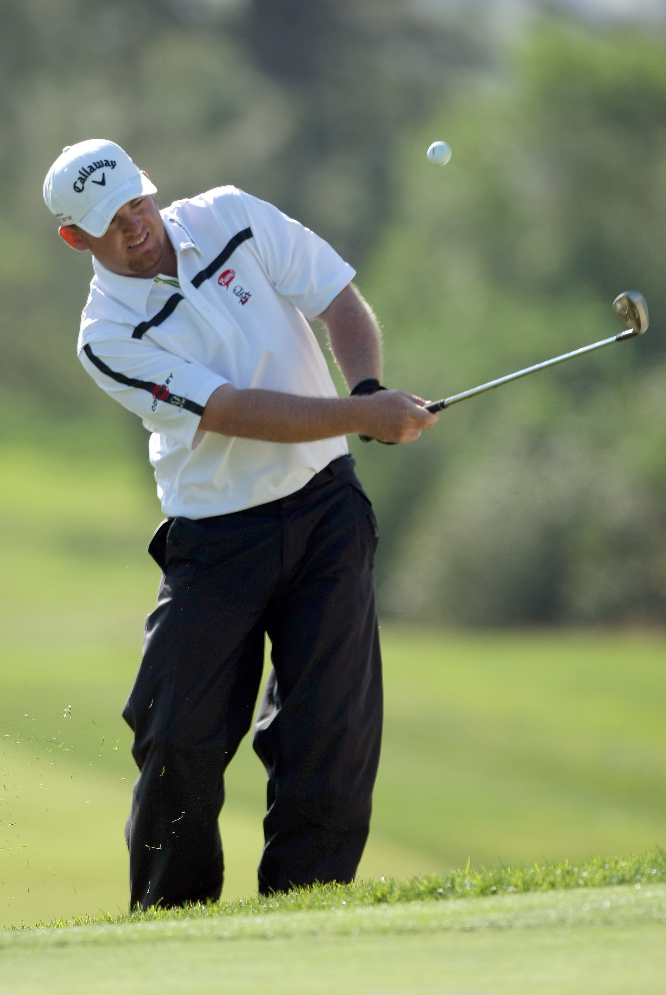 LA JOLLA, CA - JANUARY 29:  J.B. Holmes hits out of the rough on the 17th hole during Round 3 of the Farmers Insurance Open at Torrey Pines on January 29, 2011 in La Jolla, California. (Photo by Donald Miralle/Getty Images)