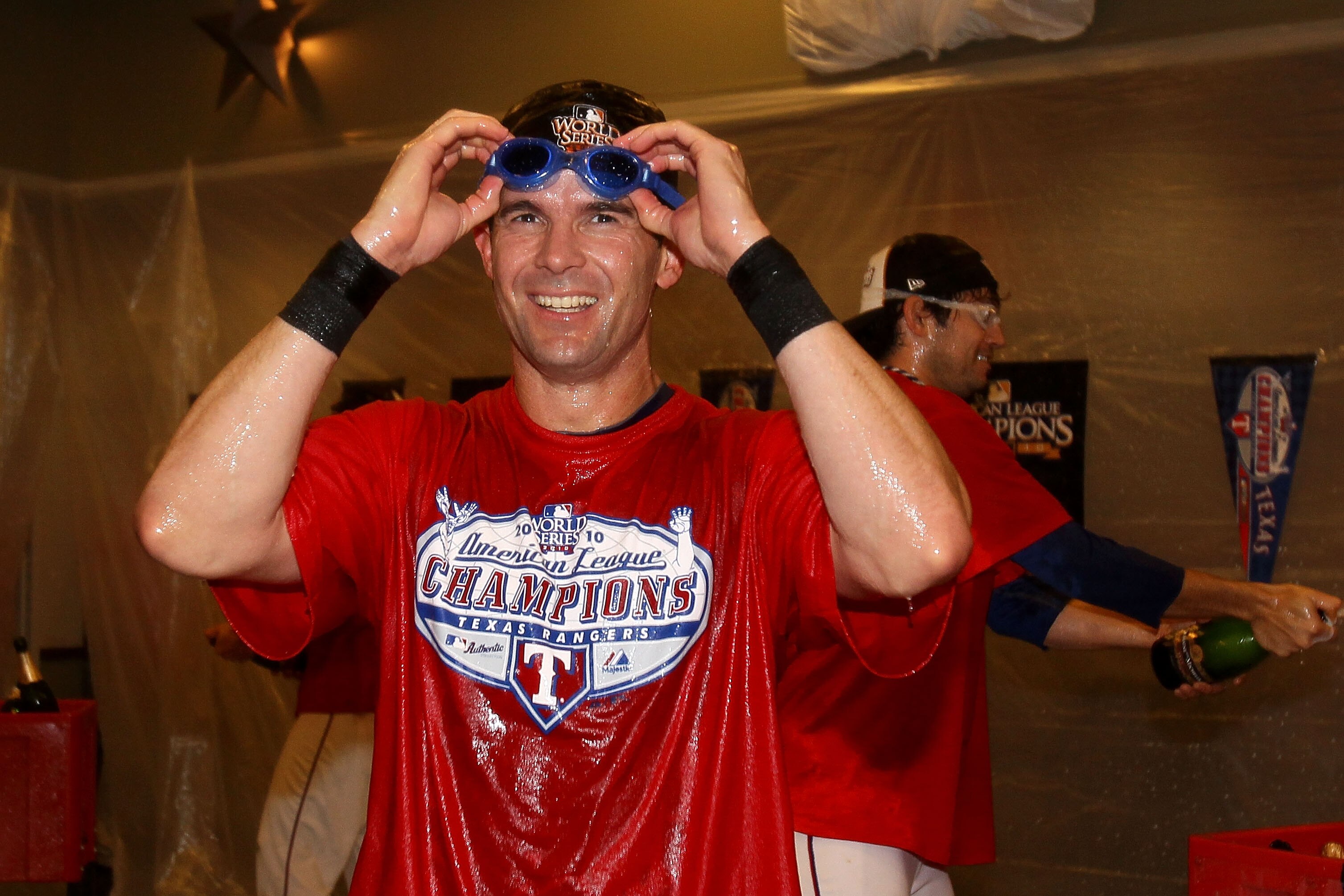 ARLINGTON, TX - OCTOBER 22:  Michael Young #10 of the Texas Rangers celebrates in the lockerroom after defeating the New York Yankees 6-1 in Game Six of the ALCS to advance to the World Series during the 2010 MLB Playoffs at Rangers Ballpark in Arlington