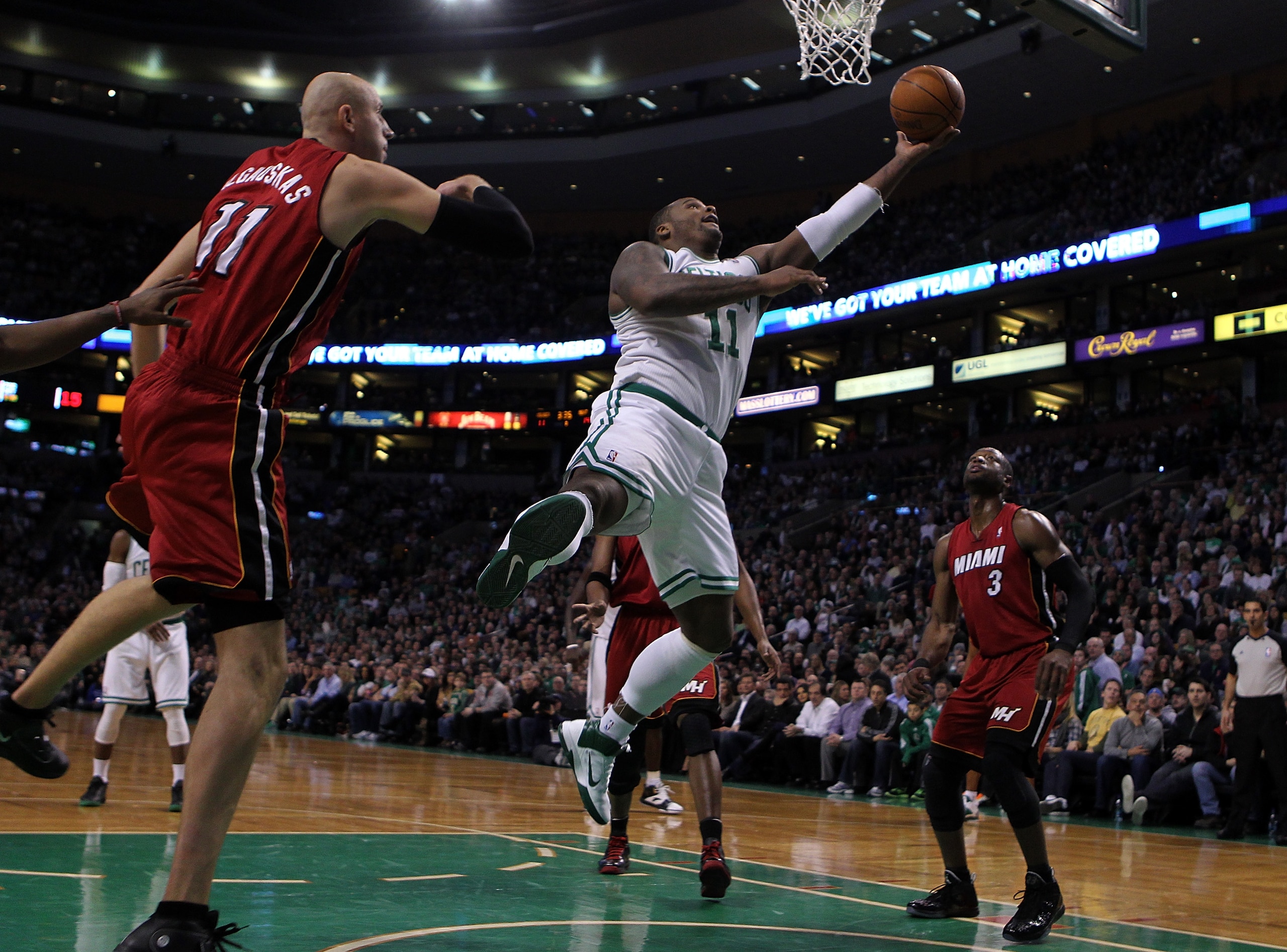 BOSTON - FEBRUARY 13:  Glen Davis #11 of the Boston Celtics drives against Zydrunas Ilgauskas #11 of the Miami Heat at TD Garden on February 13, 2011 in Boston, Massachusetts. The Celtics won 85-82. NOTE TO USER: User expressly acknowledges and agrees tha