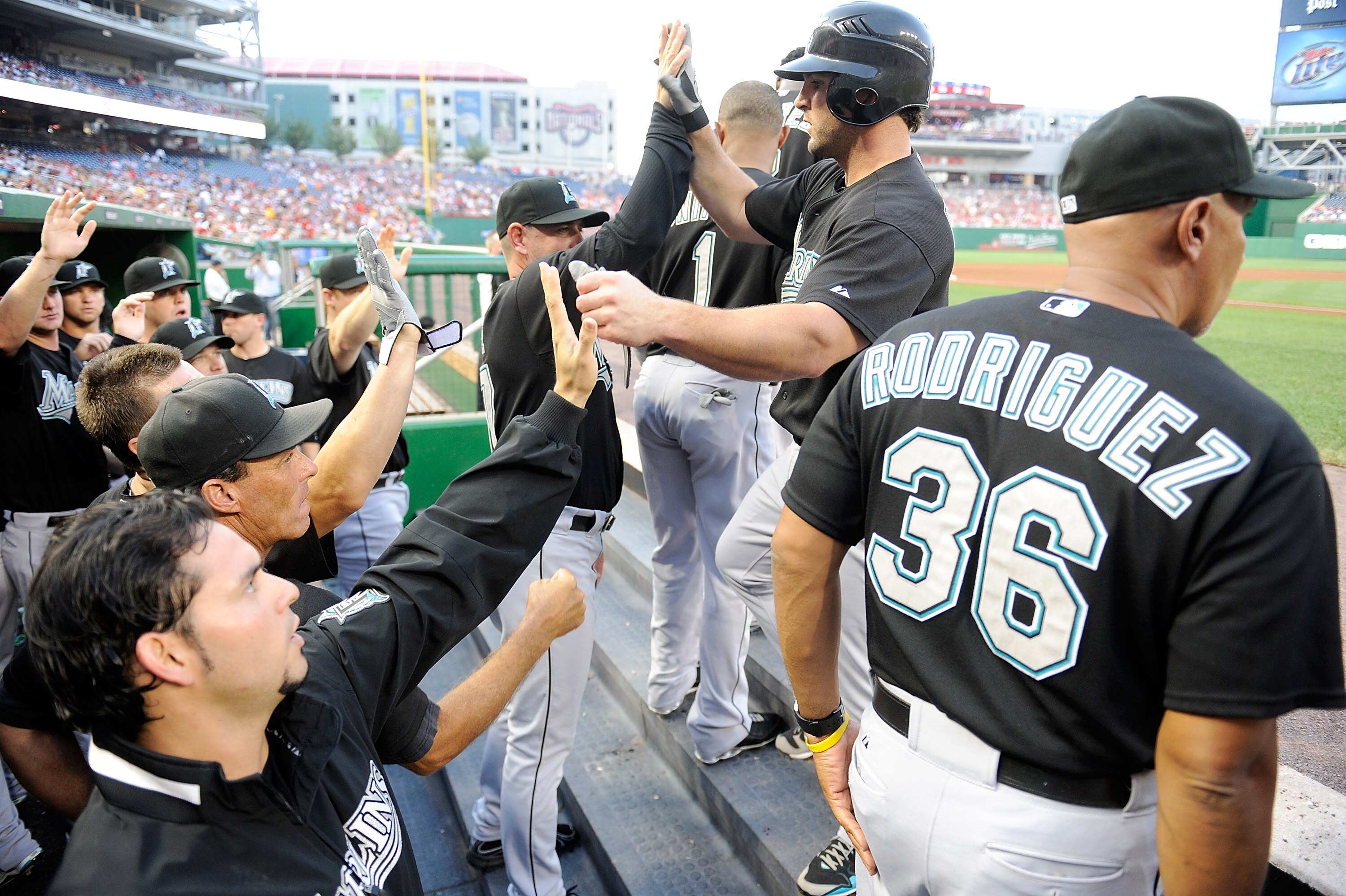 WASHINGTON - AUGUST 10:  Dan Uggla #6 of the Florida Marlins is congratulated by teammates after hitting a home run in the first inning against the Washington Nationals at Nationals Park on August 10, 2010 in Washington, DC.  (Photo by Greg Fiume/Getty Im