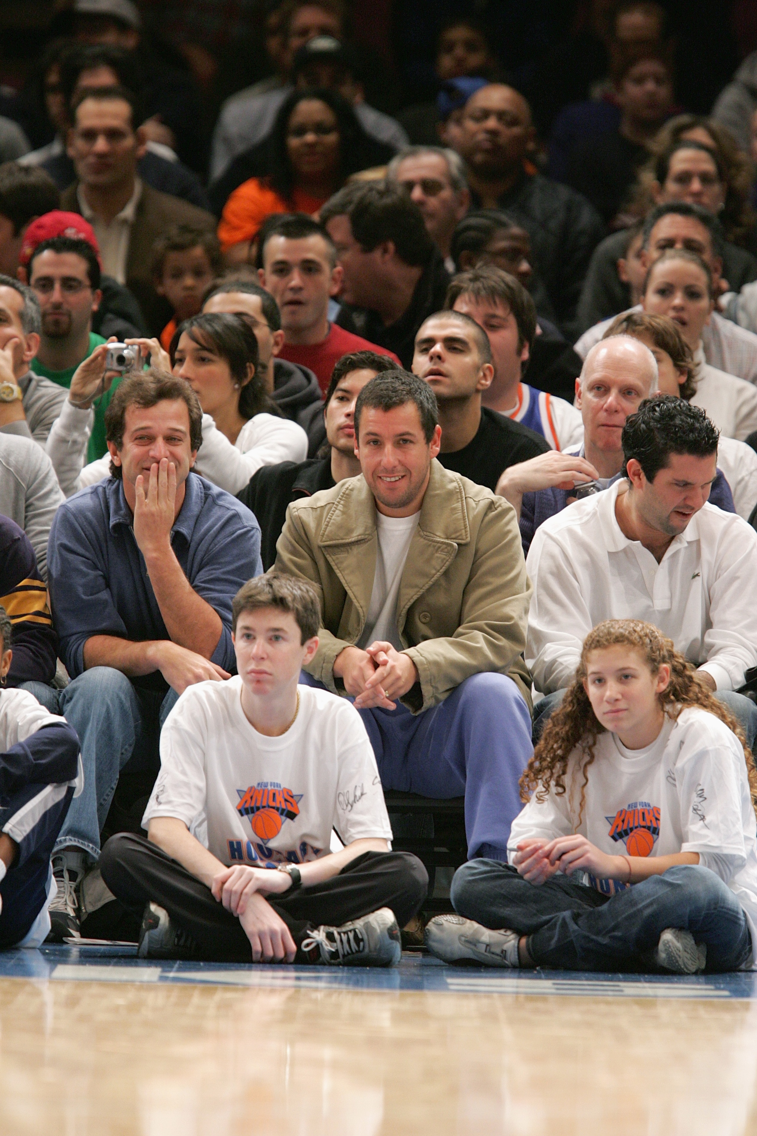 NEW YORK - DECEMBER 12:  New York Knicks fans Allen Covert (L) and Adam Sandler watch the game with the Denver Nuggets on December 12 2004 at Madison Square Garden in New York City, New York. The Knicks won 107-96. NOTE TO USER: User expressly acknowledge