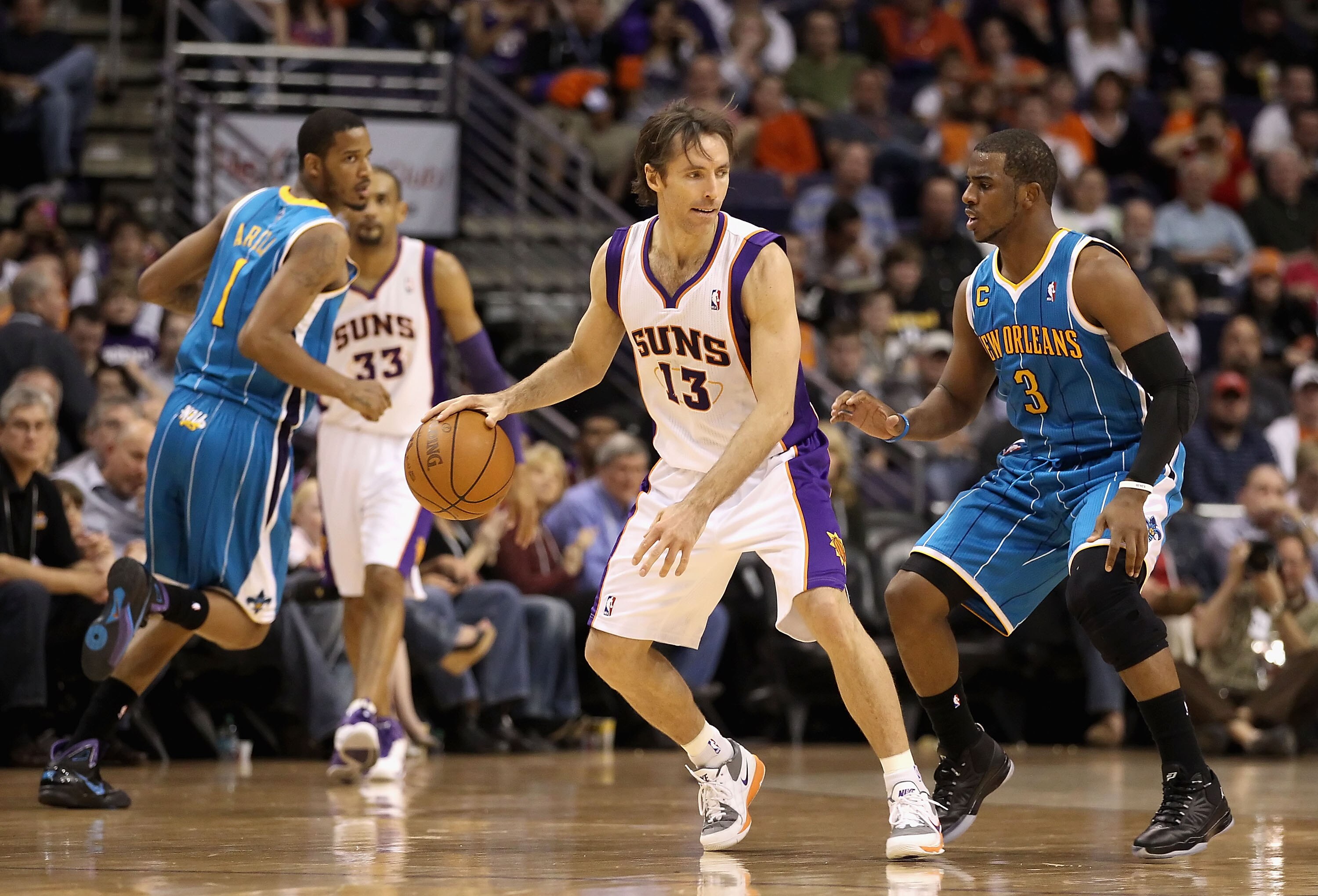 PHOENIX, AZ - JANUARY 30:  Steve Nash #13 of the Phoenix Suns handles the ball during the NBA game against the New Orleans Hornets at US Airways Center on January 30, 2011 in Phoenix, Arizona.  The Suns defeated the Hornets 104-102. NOTE TO USER: User exp