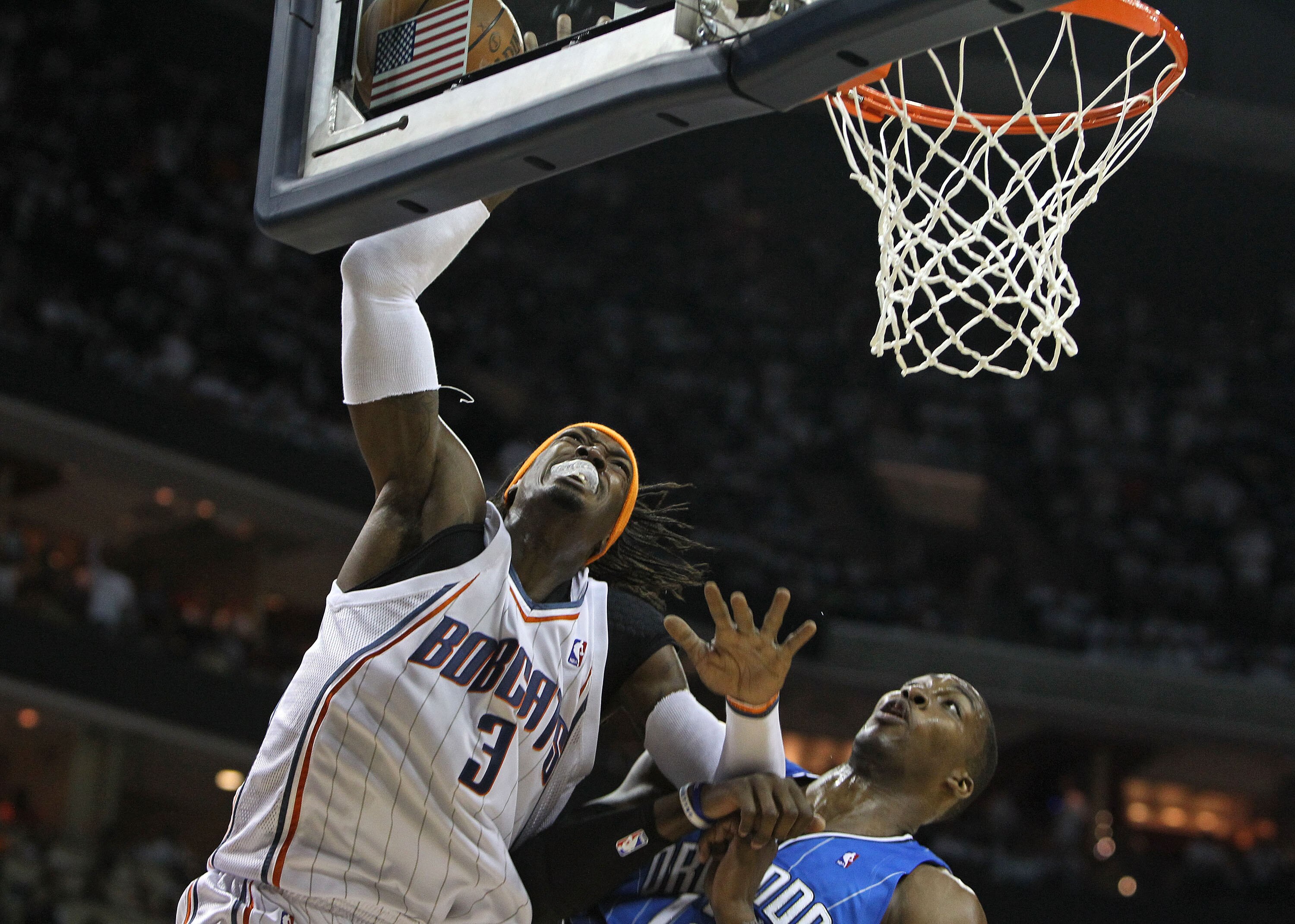 CHARLOTTE, NC - APRIL 24:  Forward Gerald Wallace #3 of the Charlotte Bobcats goes up for a shot while center Dwight Howard #12 of the Orlando Magic defends him during Game Three of the Eastern Conference Quarterfinals during the 2010 NBA Playoffs at Time