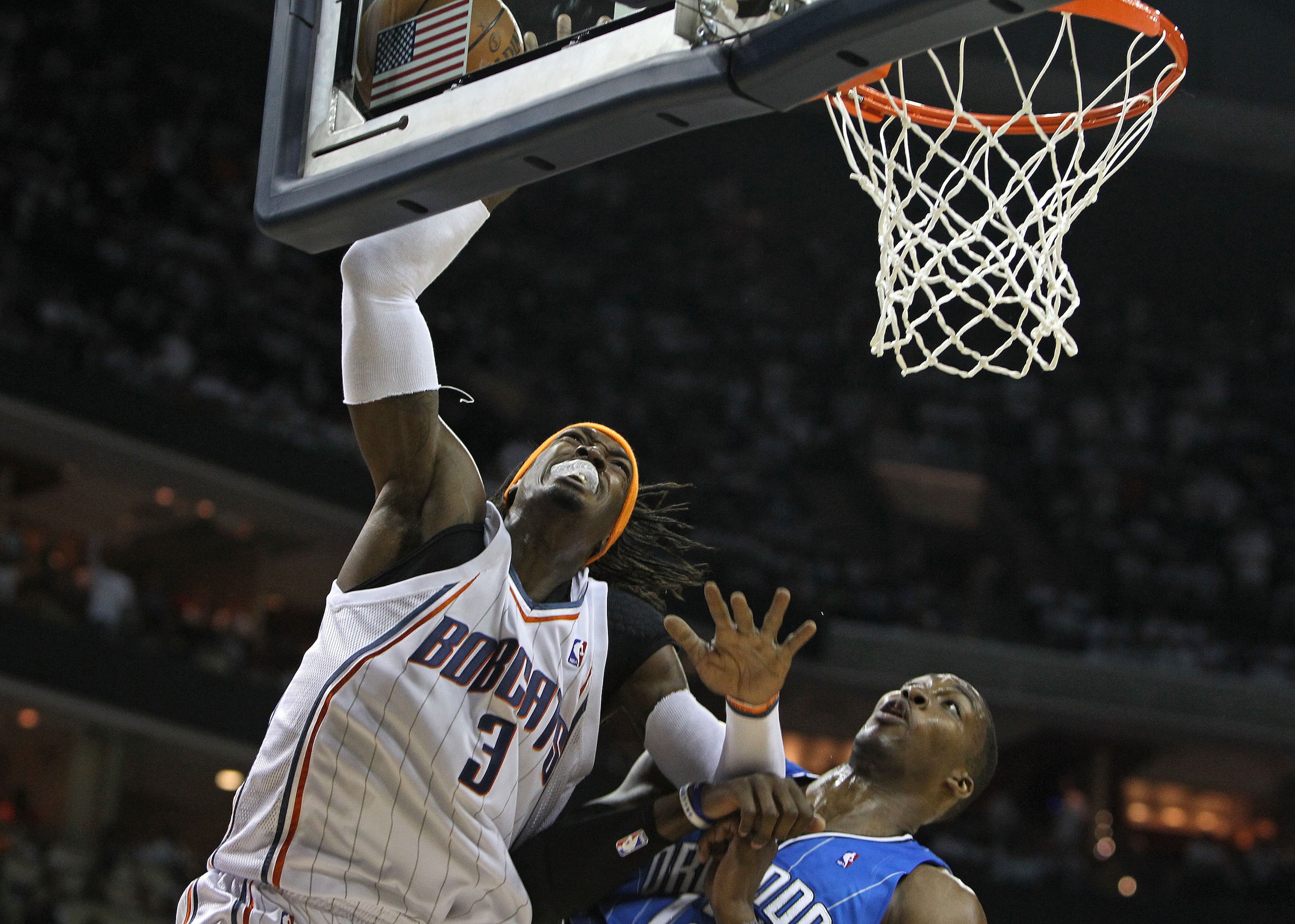 CHARLOTTE, NC - APRIL 24:  Forward Gerald Wallace #3 of the Charlotte Bobcats goes up for a shot while center Dwight Howard #12 of the Orlando Magic defends him during Game Three of the Eastern Conference Quarterfinals during the 2010 NBA Playoffs at Time