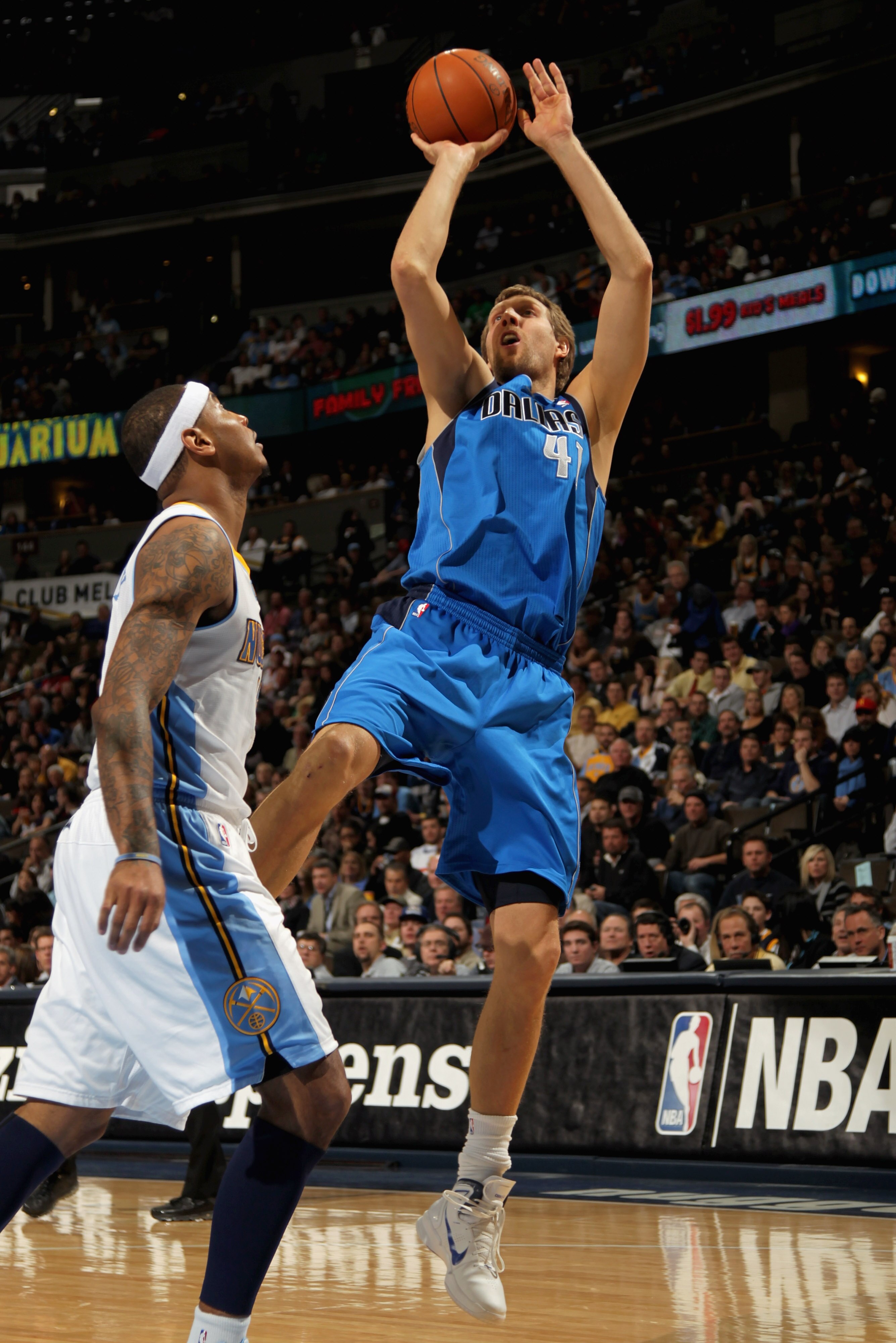 DENVER, CO - FEBRUARY 10:  Dirk Nowitzki #41 of the Dallas Mavericks takes a shot over Carmelo Anthony #15 of the Denver Nuggets during NBA action at the Pepsi Center on February 10, 2011 in Denver, Colorado. NOTE TO USER: User expressly acknowledges and