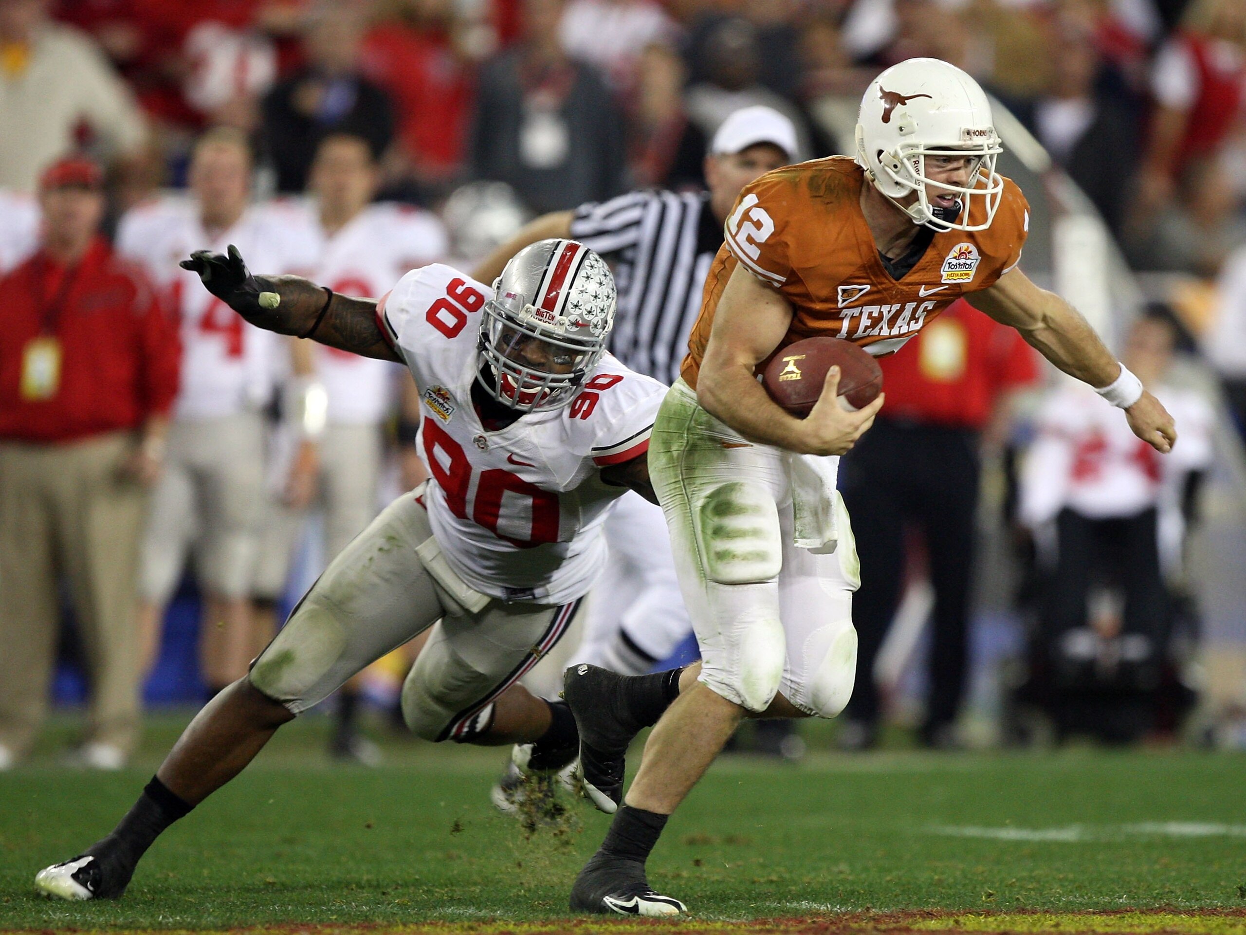 GLENDALE, AZ - JANUARY 05: Quarterback Colt McCoy #12 of the Texas Longhorns scrambles from Thaddeus Gibson #90 of the Ohio State Buckeyes in the Tostitos Fiesta Bowl Game on January 5, 2009 at University of Phoenix Stadium in Glendale, Arizona. The Long GLENDALE, AZ - JANUARY 05: Quarterback Colt McCoy #12 of the Texas Longhorns scrambles from Thaddeus Gibson #90 of the Ohio State Buckeyes in the Tostitos Fiesta Bowl Game on January 5, 2009 at University of Phoenix Stadium in Glendale, Arizona. The Long