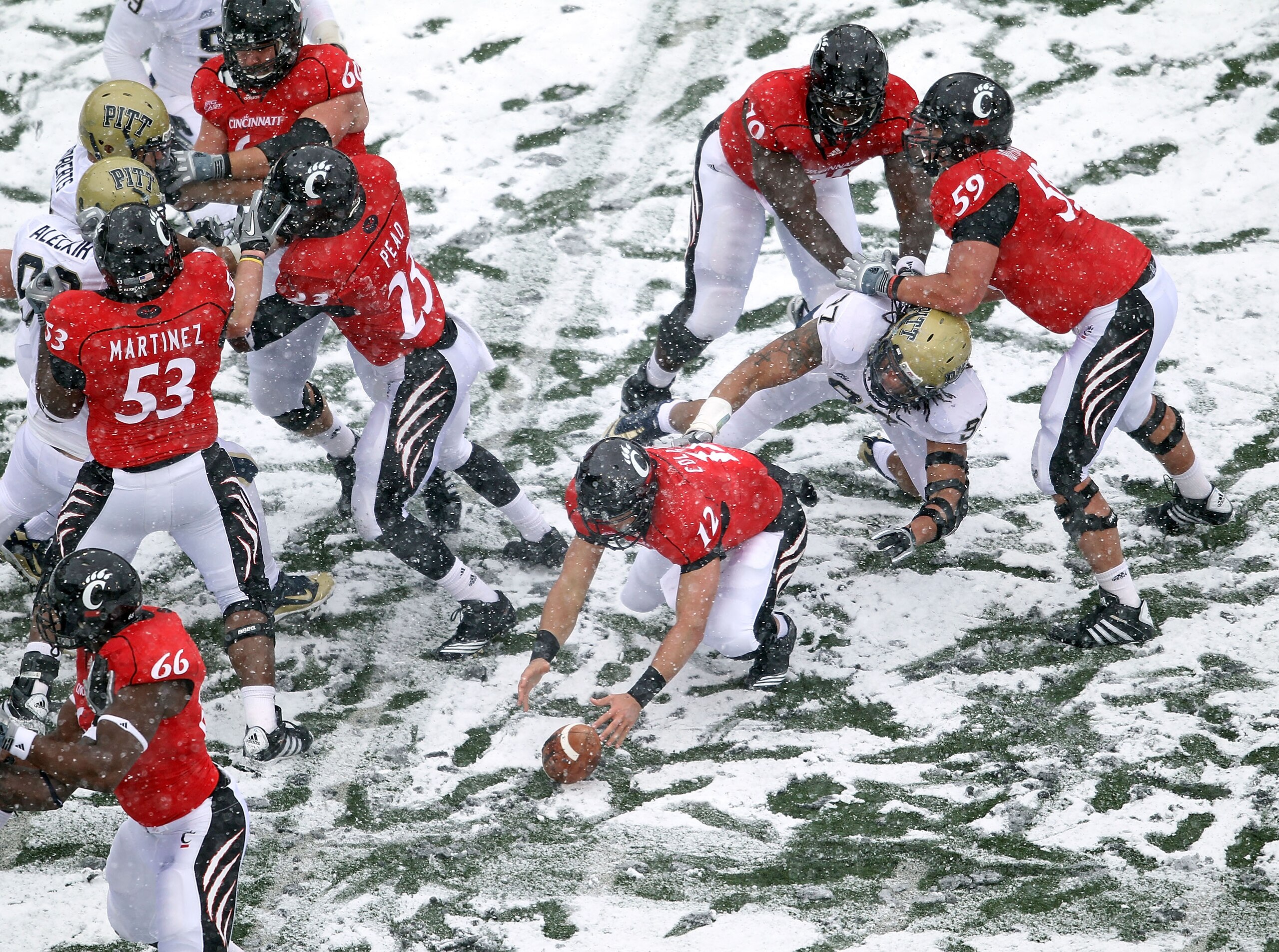 CINCINNATI, OH - DECEMBER 04: Zach Collaros #12 of the Cincinnati Bearcats reaches for a fumble during the Big East Conference game against the Pittsburgh Panthers at Nippert Stadium on December 4, 2010 in Cincinnati, Ohio. Pittsburgh won 28-10. (Photo CINCINNATI, OH - DECEMBER 04: Zach Collaros #12 of the Cincinnati Bearcats reaches for a fumble during the Big East Conference game against the Pittsburgh Panthers at Nippert Stadium on December 4, 2010 in Cincinnati, Ohio. Pittsburgh won 28-10. (Photo