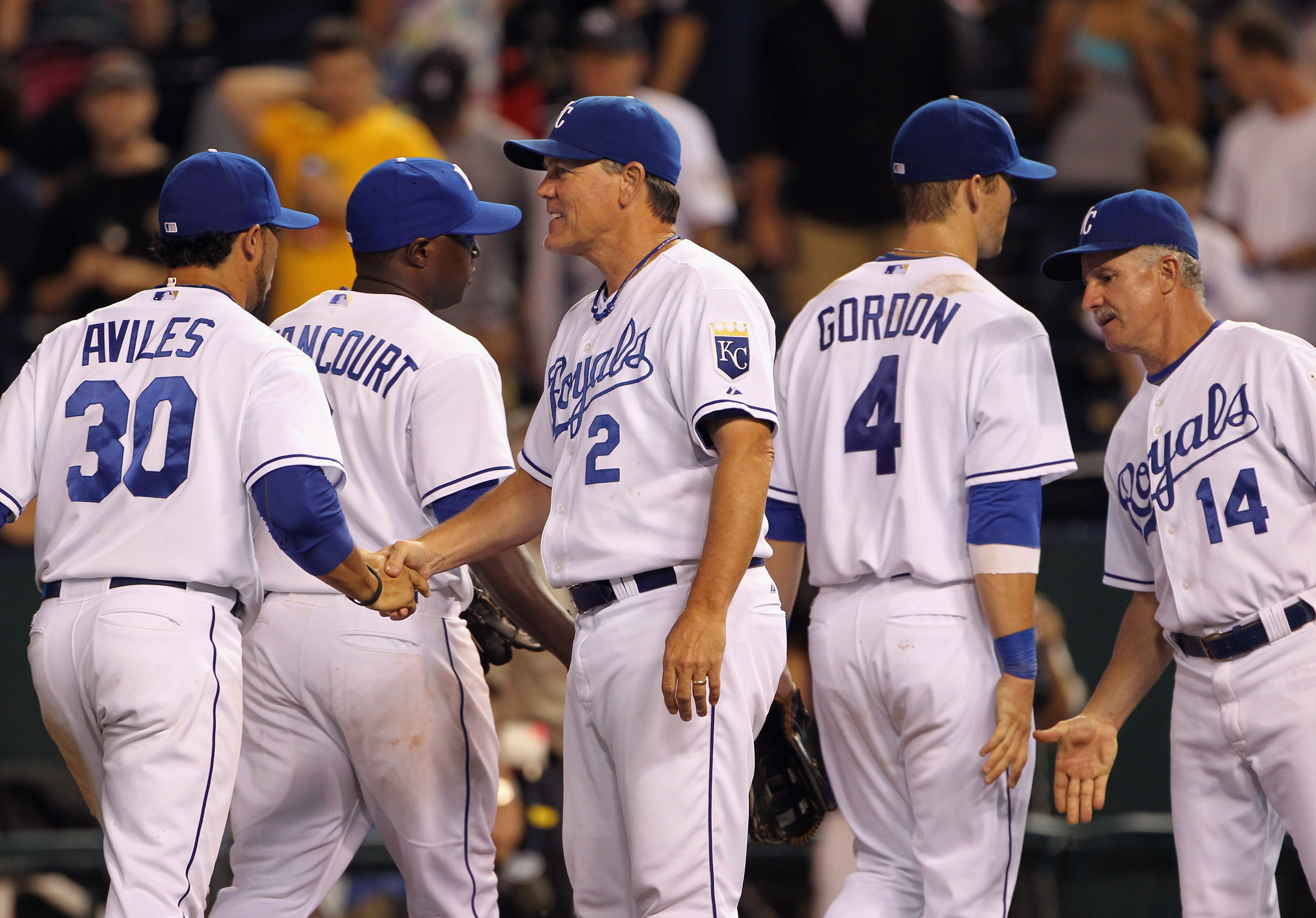 KANSAS CITY, MO - AUGUST 13:  Manager Ned Yost #2 of the Kansas City Royals congratulates players after the Royals defeated the New York Yankees 4-3 to win the game on August 13, 2010 at Kauffman Stadium in Kansas City, Missouri.  (Photo by Jamie Squire/G