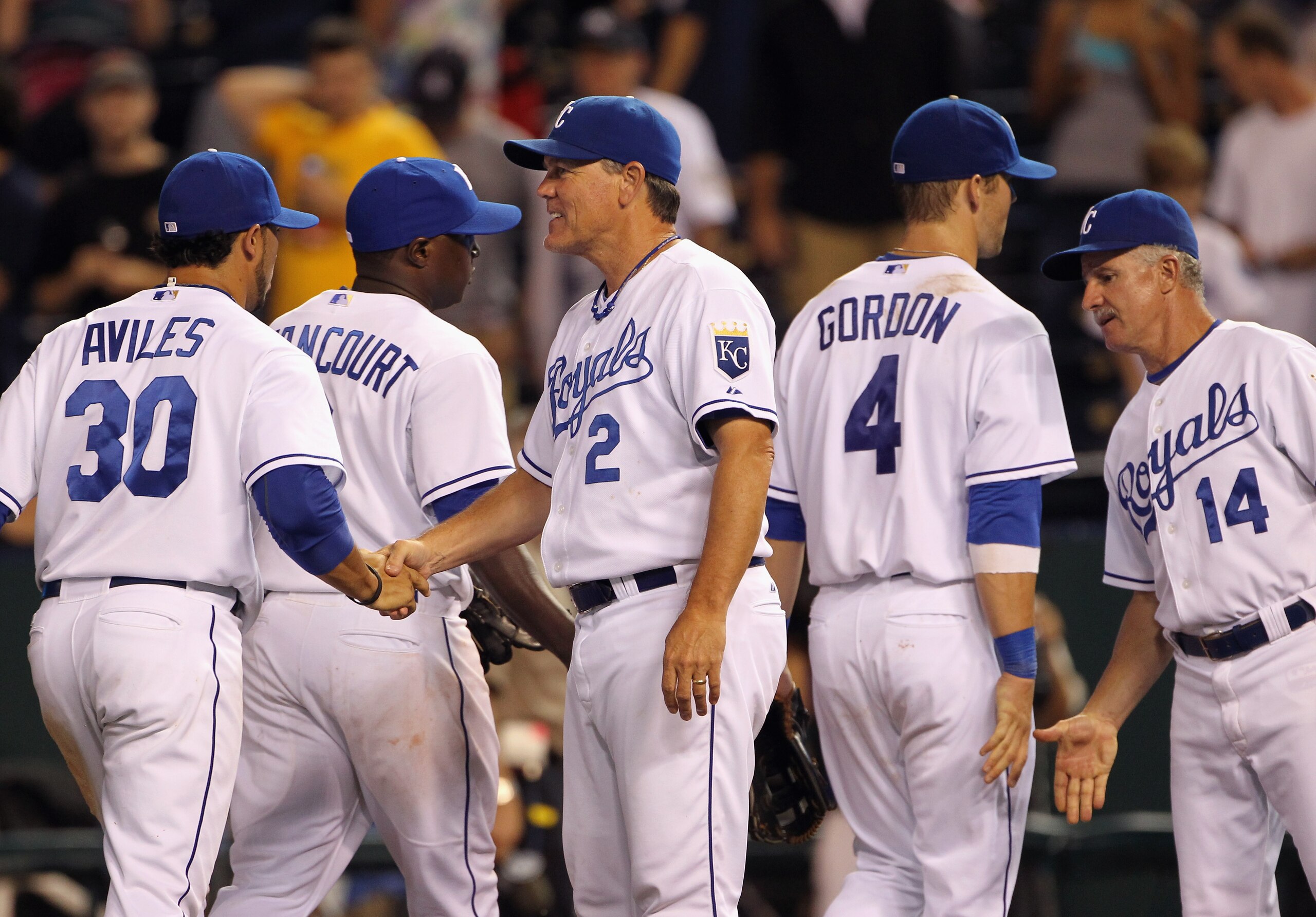 KANSAS CITY, MO - AUGUST 13:  Manager Ned Yost #2 of the Kansas City Royals congratulates players after the Royals defeated the New York Yankees 4-3 to win the game on August 13, 2010 at Kauffman Stadium in Kansas City, Missouri.  (Photo by Jamie Squire/G