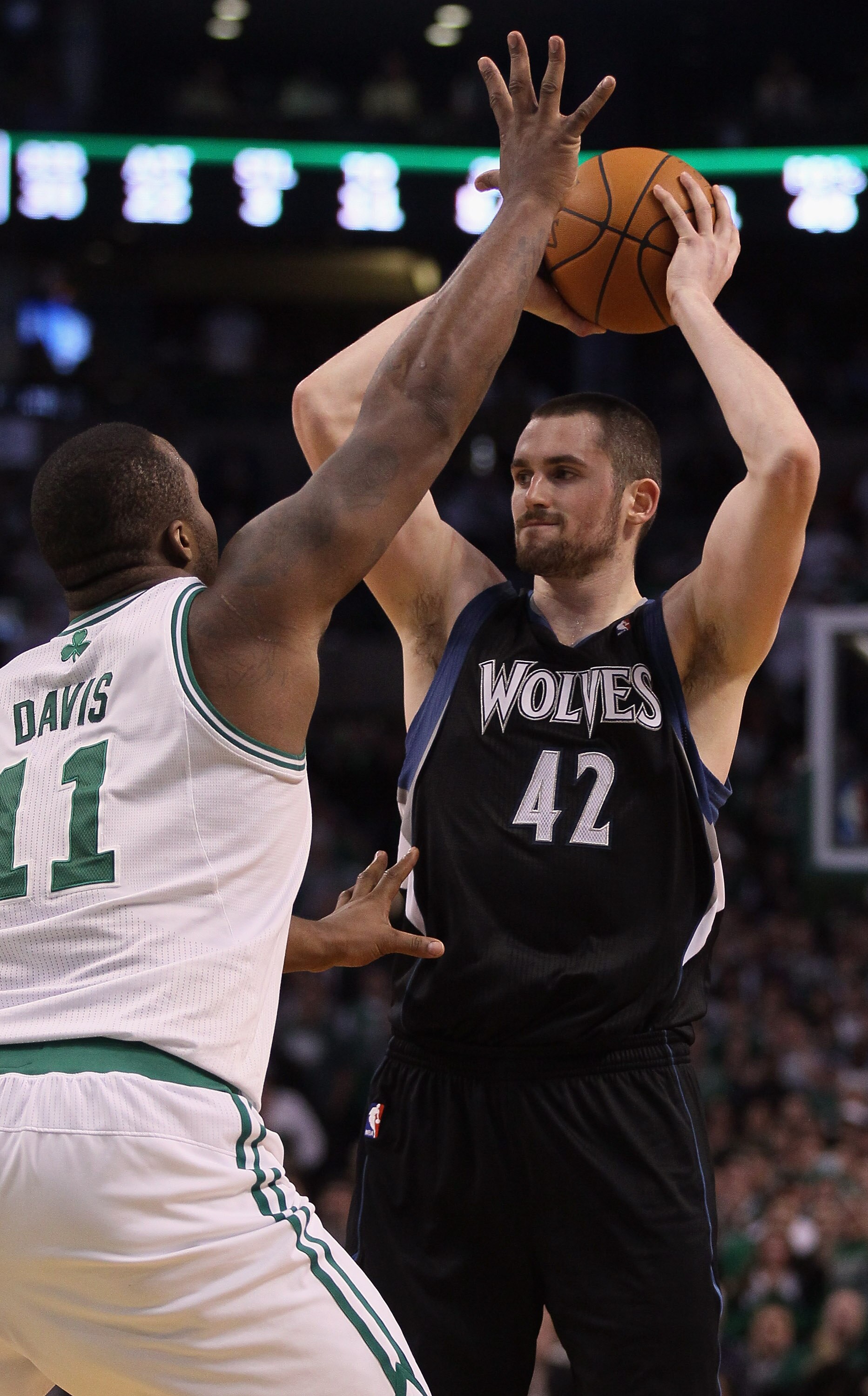 BOSTON, MA - JANUARY 03:  Kevin Love #42 of the Minnesota Timberwolves looks to pass as Glen Davis #11 of the Boston Celtics defends on January 3, 2011 at the TD Garden in Boston, Massachusetts. The Celtics defeated the Timberwolves 96-93. NOTE TO USER: U