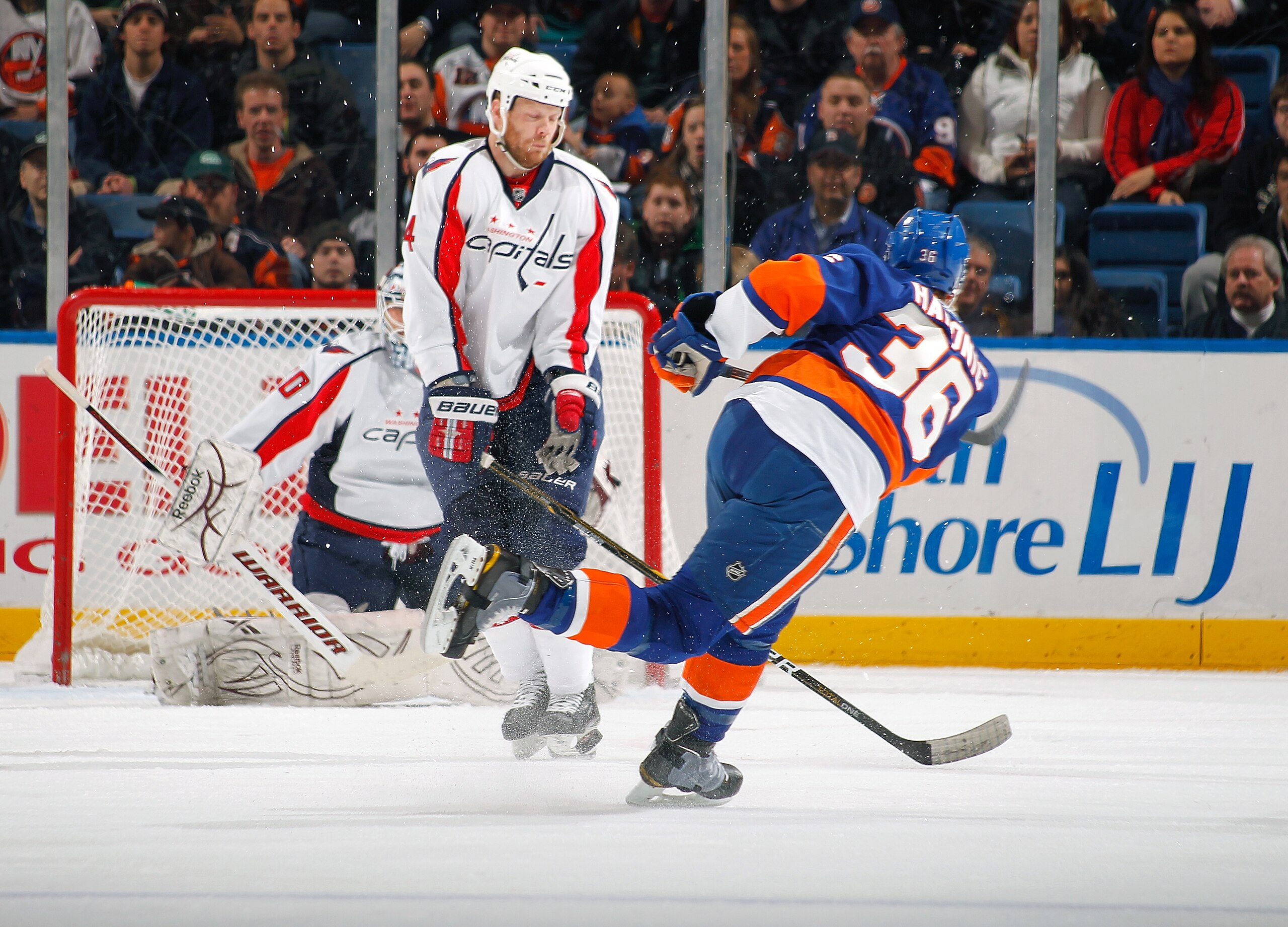UNIONDALE, NY - JANUARY 20:  John Erskine #4 of the Washington Capitals blocks a shot by Travis Hamonic #36 of the New York Islanders on January 20, 2011 at Nassau Coliseum in Uniondale, New York.  (Photo by Lou Capozzola/Getty Images)