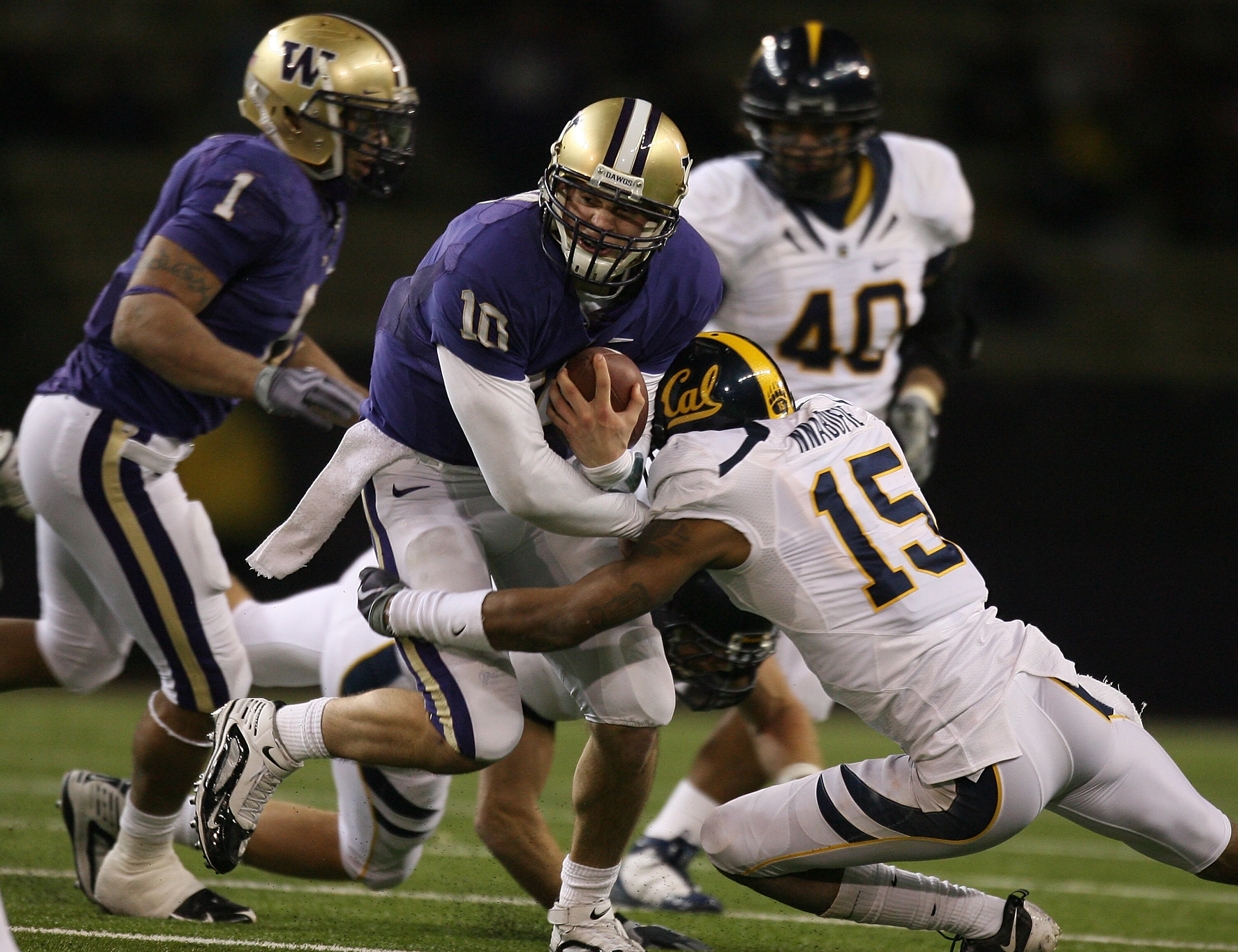SEATTLE - DECEMBER 05:  Quarterback Jake Locker #10 of the Washington Huskies rushes against Bryant Nnabuife #15 of the California Bears on December 5, 2009 at Husky Stadium in Seattle, Washington. The Huskies defeated the Bears 42-10. (Photo by Otto Greu