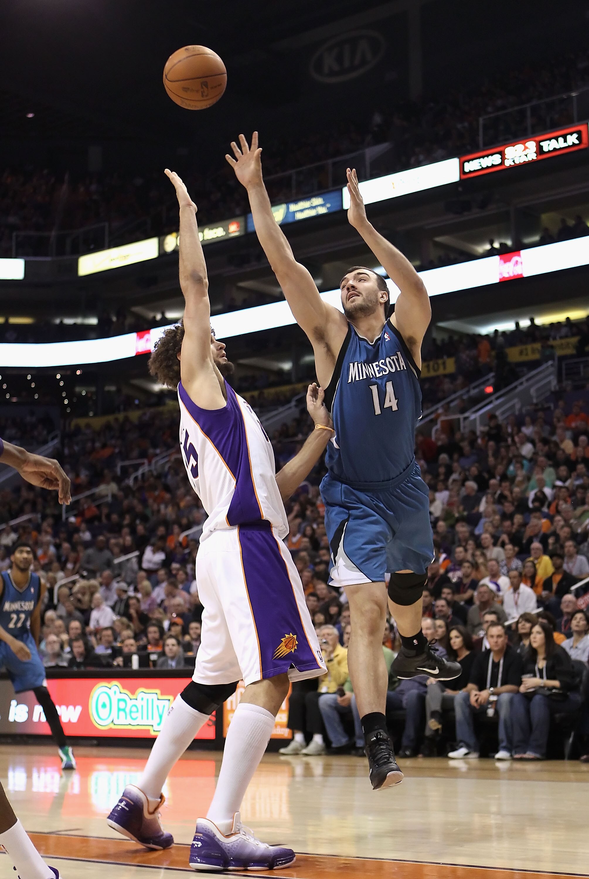 PHOENIX - DECEMBER 15:  Nikola Pekovic #14 of the Minnesota Timberwolves puts up a shot over Robin Lopez #15 of the Phoenix Suns during the NBA game at US Airways Center on December 15, 2010 in Phoenix, Arizona. NOTE TO USER: User expressly acknowledges a