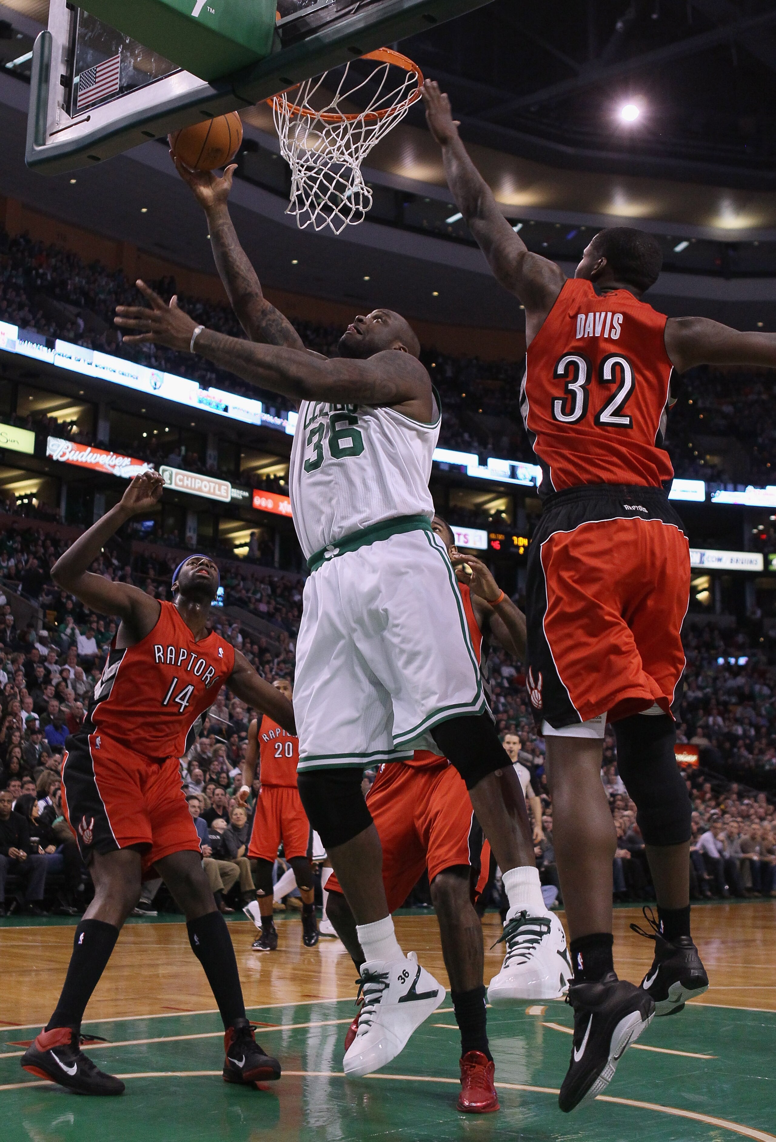 BOSTON, MA - JANUARY 07: Shaquille O'Neal #36 of the Boston Celtics heads for the basket as Julian Wright #14 and Ed Davis #32 of the Toronto Raptors defend on January 7, 2011 at the TD Garden in Boston, Massachusetts. NOTE TO USER: User expressly acknow BOSTON, MA - JANUARY 07: Shaquille O'Neal #36 of the Boston Celtics heads for the basket as Julian Wright #14 and Ed Davis #32 of the Toronto Raptors defend on January 7, 2011 at the TD Garden in Boston, Massachusetts. NOTE TO USER: User expressly acknow