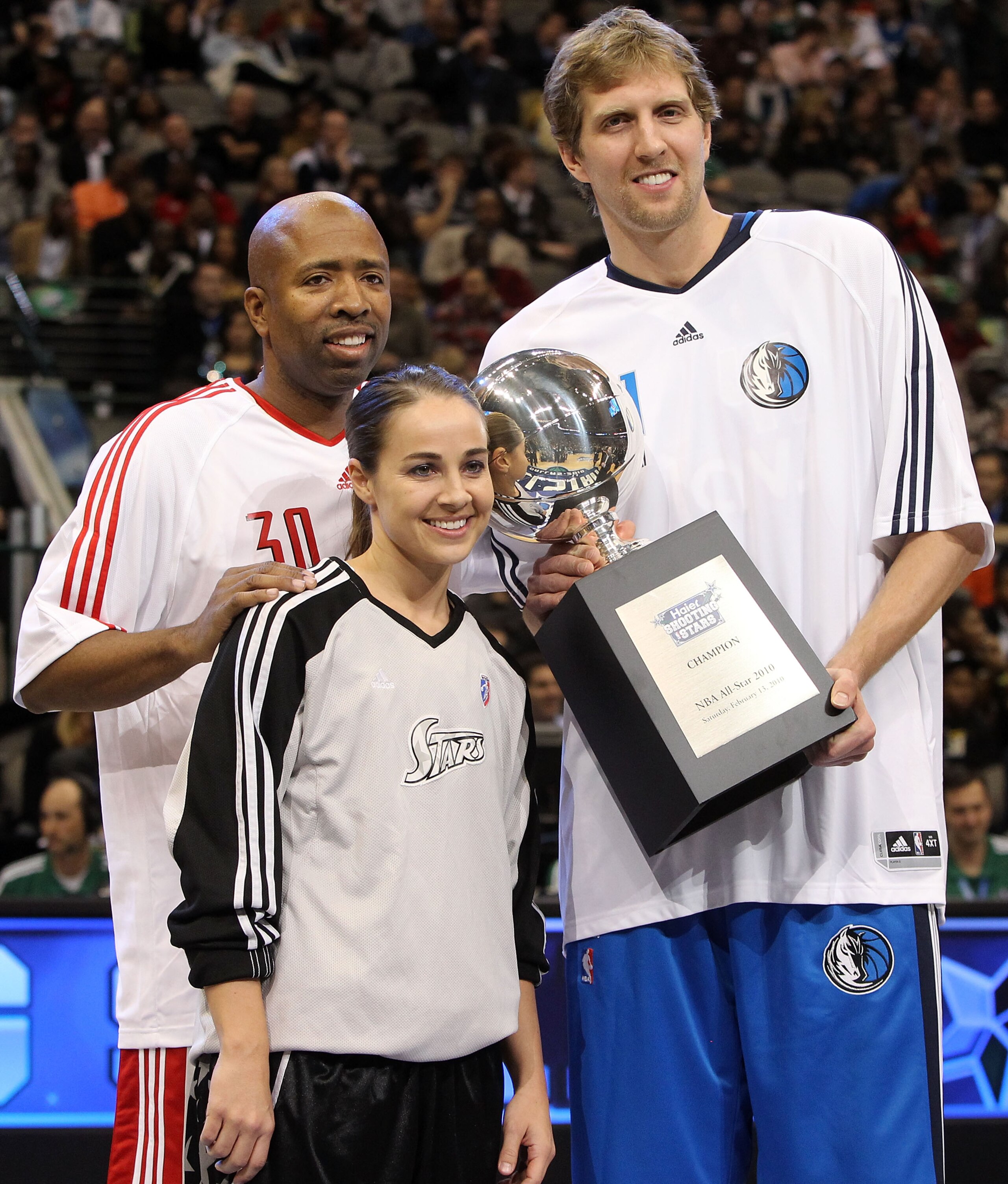 DALLAS - FEBRUARY 13:  TNT analyst Kenny Smith #30 formerly of the Houston Rockets, Becky Hammon #25 and Dirk Nowitzki #41 of the Dallas Mavericks, all of team Texas, hold the Champions Trophy after winning the Haier Shooting Stars Competition on All-Star