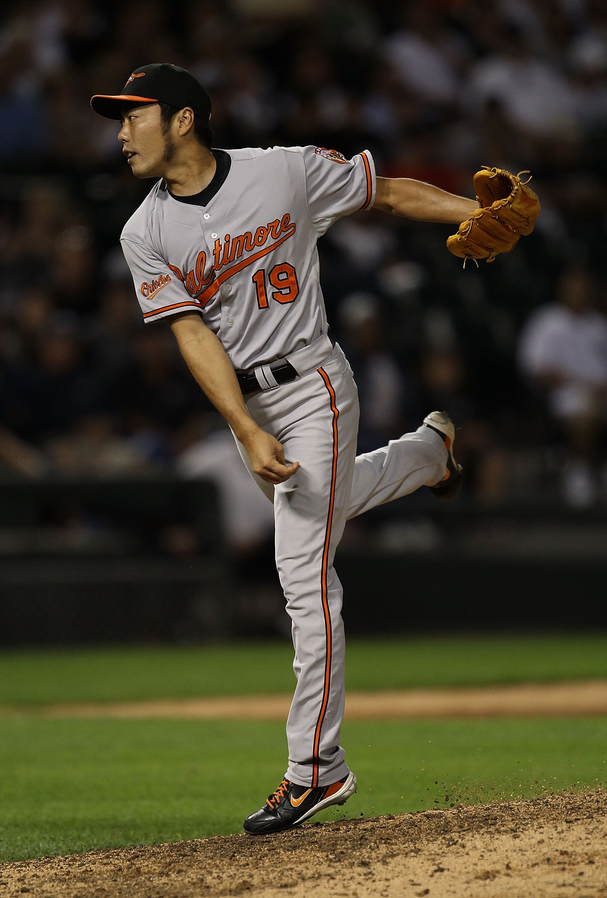 CHICAGO - AUGUST 25: Koji Uehara #19 of the Baltimore Orioles follows through after pitching in the 9th inning against the Chicago White Sox at U.S. Cellular Field on August 25, 2010 in Chicago, Illinois. The Orioles defeated the White Sox 4-3. (Photo by