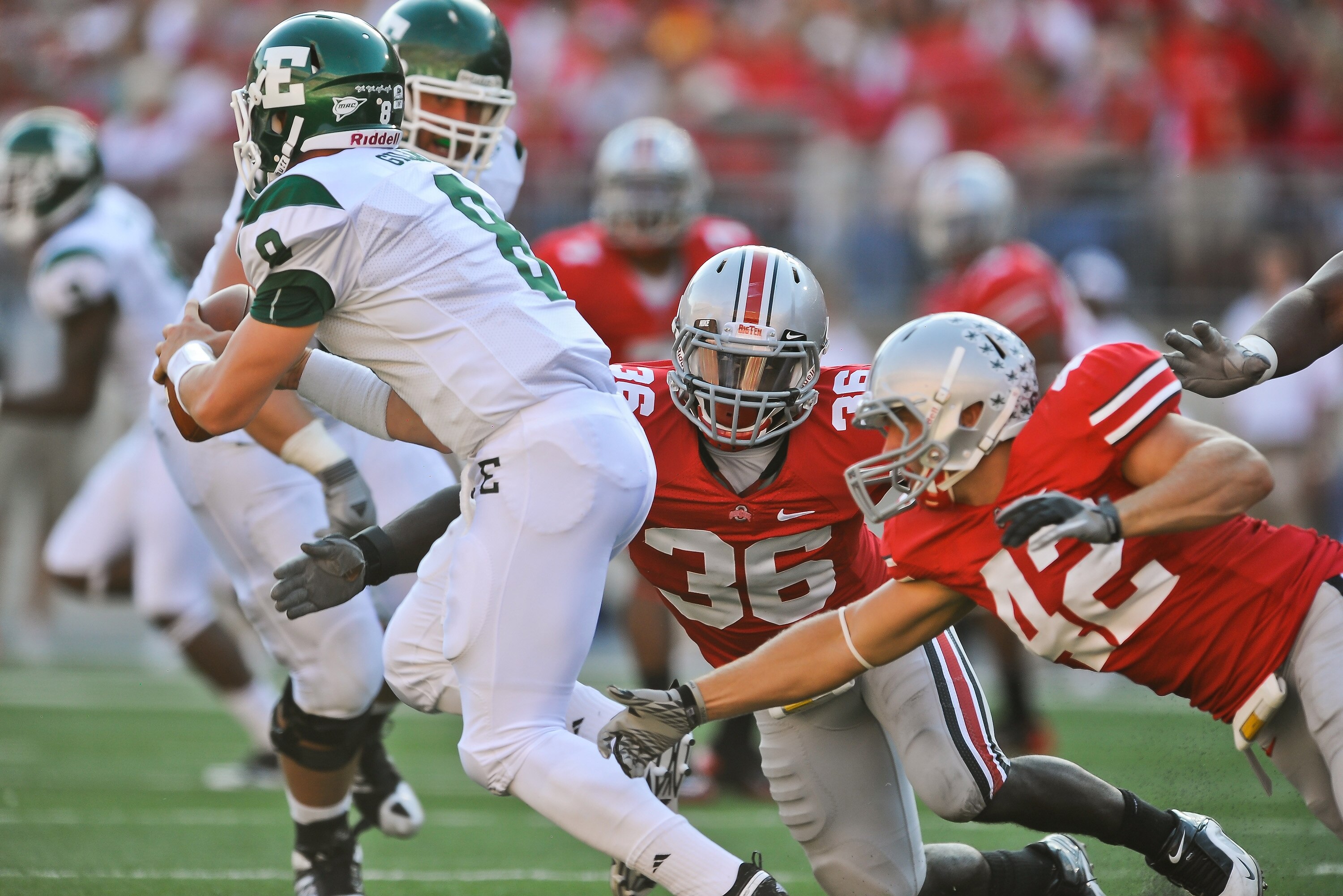COLUMBUS, OH - SEPTEMBER 25:  Brian Rolle #36 and Andrew Sweat #42 of the Ohio State Buckeyes chase after quarterback Alex Gillett #8 of the Eastern Michigan Eagles at Ohio Stadium on September 25, 2010 in Columbus, Ohio.  Ohio State won 73-20. (Photo by 