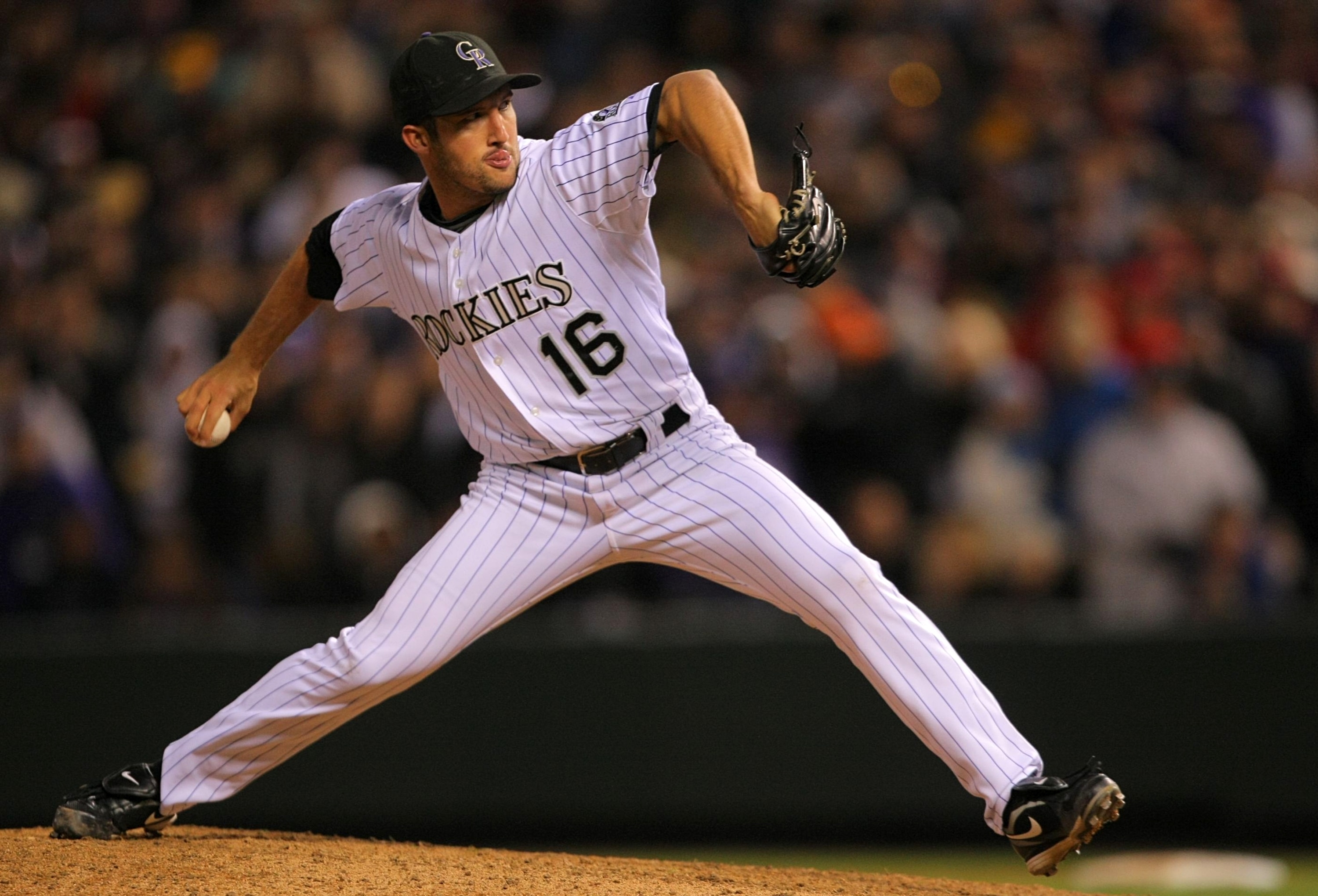 DENVER - OCTOBER 11:  Huston Street #16 of the Colorado Rockies pitches against the Philadelphia Phillies in the ninth inning in Game Four of the NLDS during the 2009 MLB Playoffs at Coors Field on October 12, 2009 in Denver, Colorado.  (Photo by Doug Pen