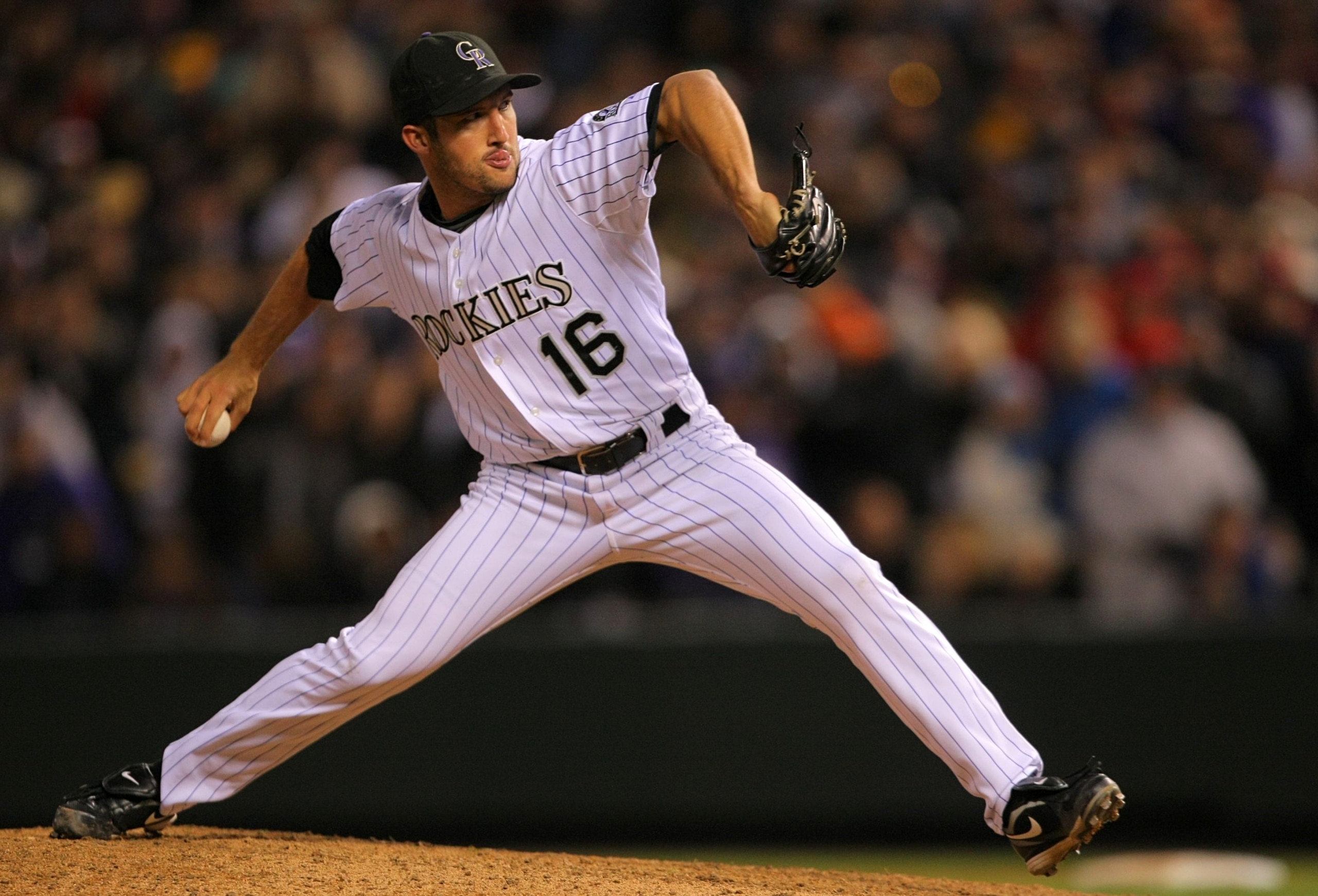 DENVER - OCTOBER 11:  Huston Street #16 of the Colorado Rockies pitches against the Philadelphia Phillies in the ninth inning in Game Four of the NLDS during the 2009 MLB Playoffs at Coors Field on October 12, 2009 in Denver, Colorado.  (Photo by Doug Pen