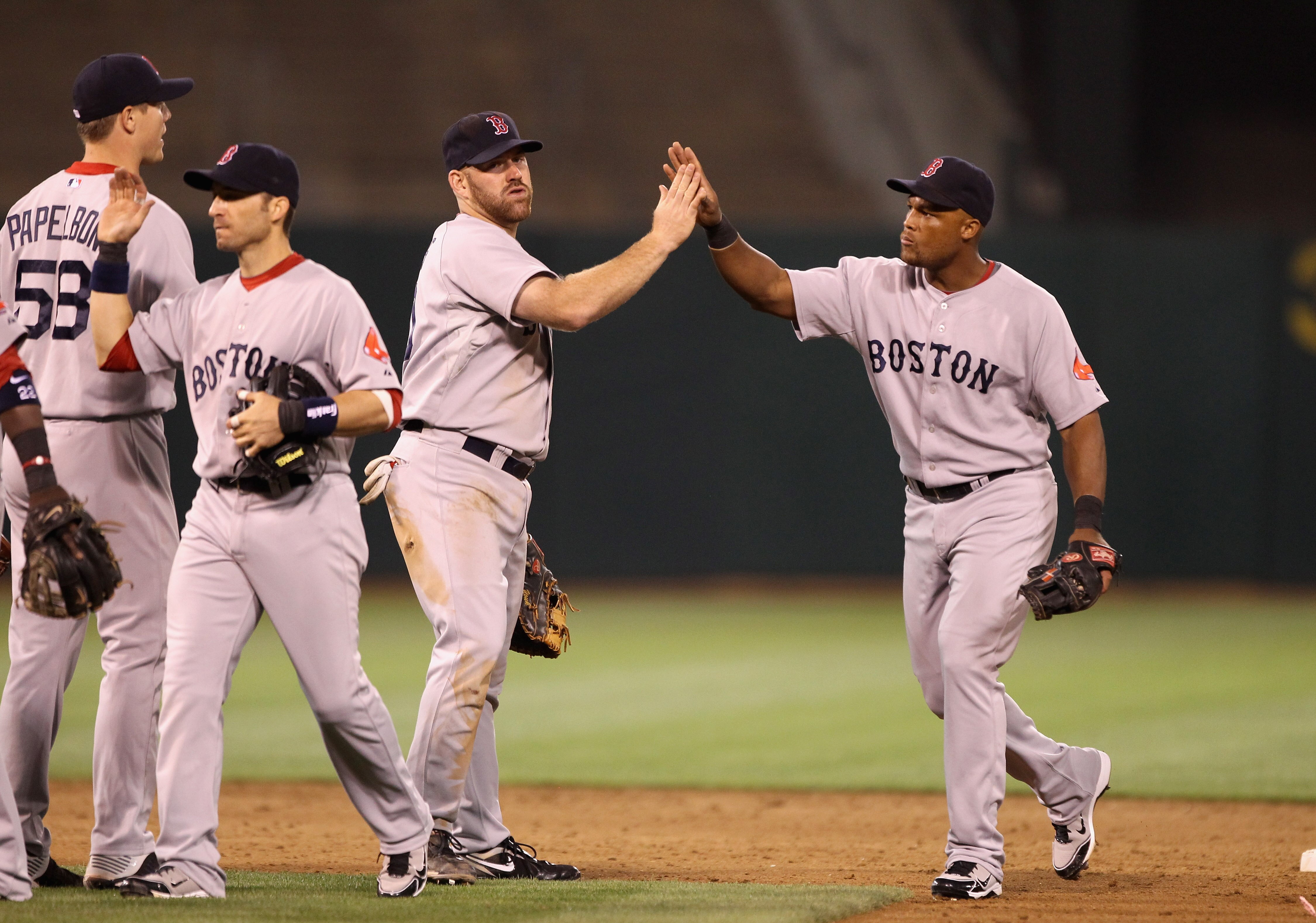 OAKLAND, CA - JULY 19:  Adrian Beltre #29 of the Boston Red Sox is congratulated by Kevin Youklis #20 after the Red Sox beat the Oakland Athletics 2-1 at the Oakland-Alameda County Coliseum on July 19, 2010 in Oakland, California.  (Photo by Ezra Shaw/Get