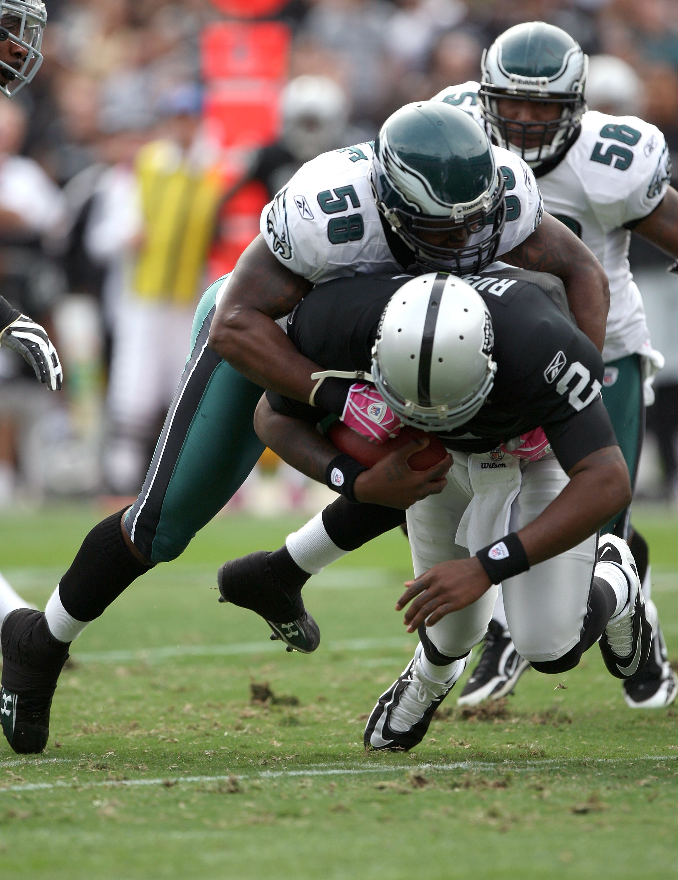 OAKLAND, CA - OCTOBER 18:  JaMarcus Russell #2 of the Oakland Raiders is sacked by Trent Cole #58 of the Philadelphia Eagles during an NFL game at the Oakland-Alameda County Coliseum on October 18, 2009 in Oakland, California.  (Photo by Jed Jacobsohn/Get