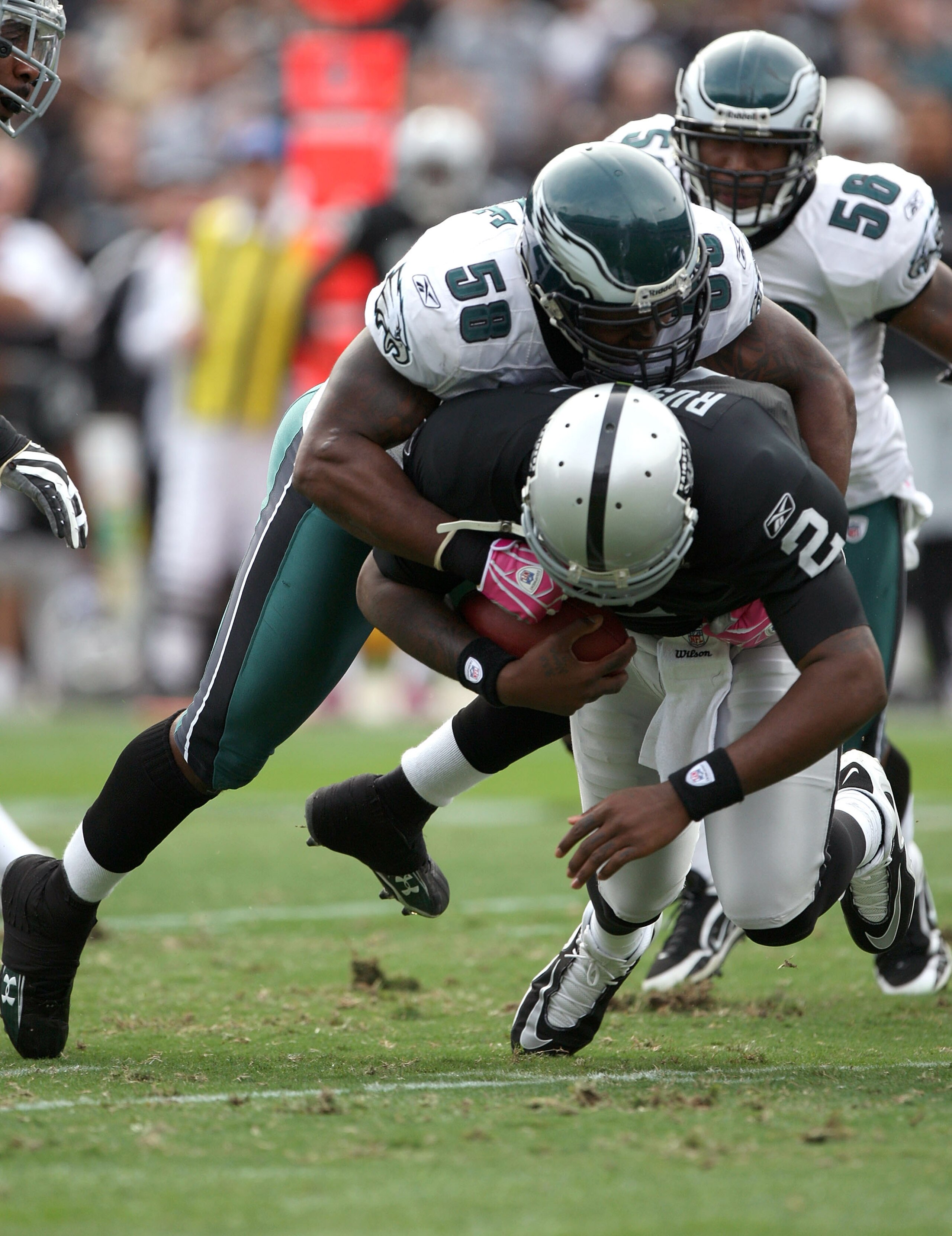 OAKLAND, CA - OCTOBER 18:  JaMarcus Russell #2 of the Oakland Raiders is sacked by Trent Cole #58 of the Philadelphia Eagles during an NFL game at the Oakland-Alameda County Coliseum on October 18, 2009 in Oakland, California.  (Photo by Jed Jacobsohn/Get
