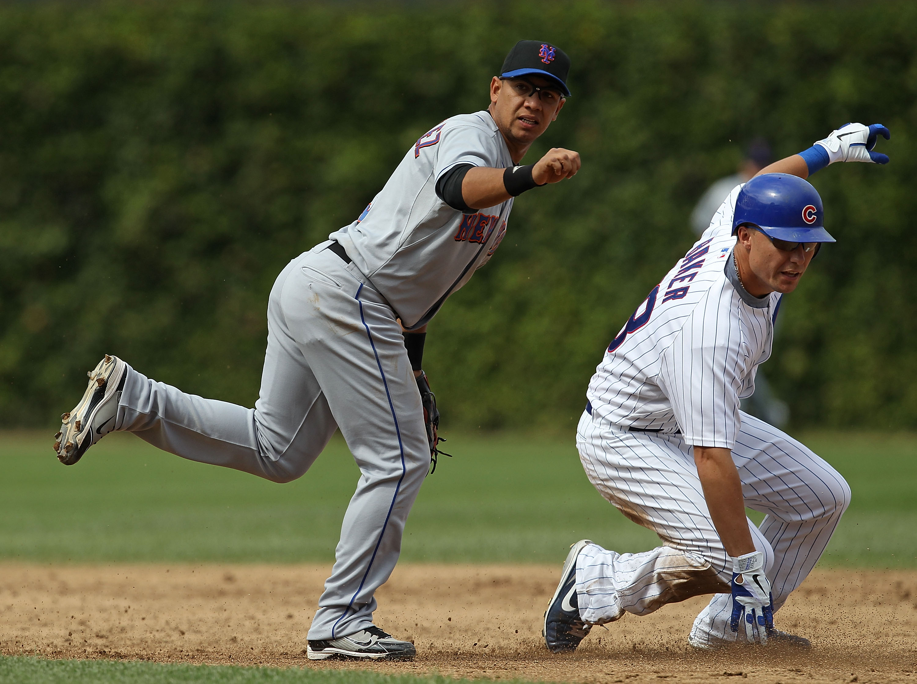 CHICAGO - SEPTEMBER 05: Luis Hernandez #3 of the New York Mets hops out of the way of Jeff Baker #28 of the Chicago Cubs after turning a double play at Wrigley Field on September 5, 2010 in Chicago, Illinois. The Mets defeated the Cubs 18-5. (Photo by Jon