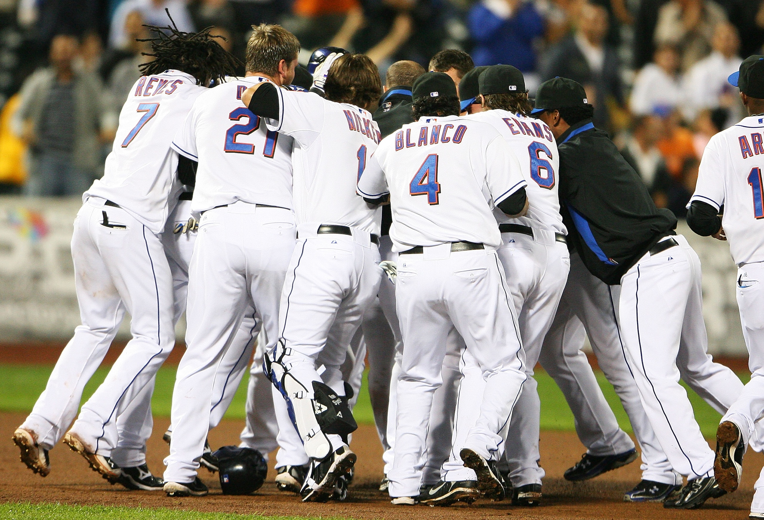 NEW YORK - SEPTEMBER 28:  Members of the New York Mets surround Ruben Tejada #11 after he hit a walk off two run double in the ninth inning to defeat the Milwaukee Brewers 4 - 3 on September 28, 2010 at Citi Field in the Flushing neighborhood of the Queen