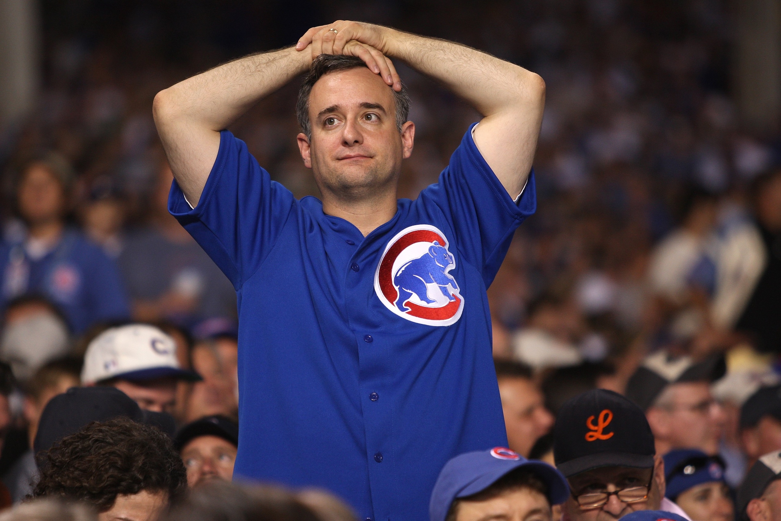 CHICAGO - OCTOBER 06:  A fan of the Chicago Cubs looks on dejected against the Arizona Diamondbacks during Game Three of the National League Divisional Series at Wrigley Field on October 6, 2007 in Chicago, Illinois.  (Photo by Jamie Squire/Getty Images)