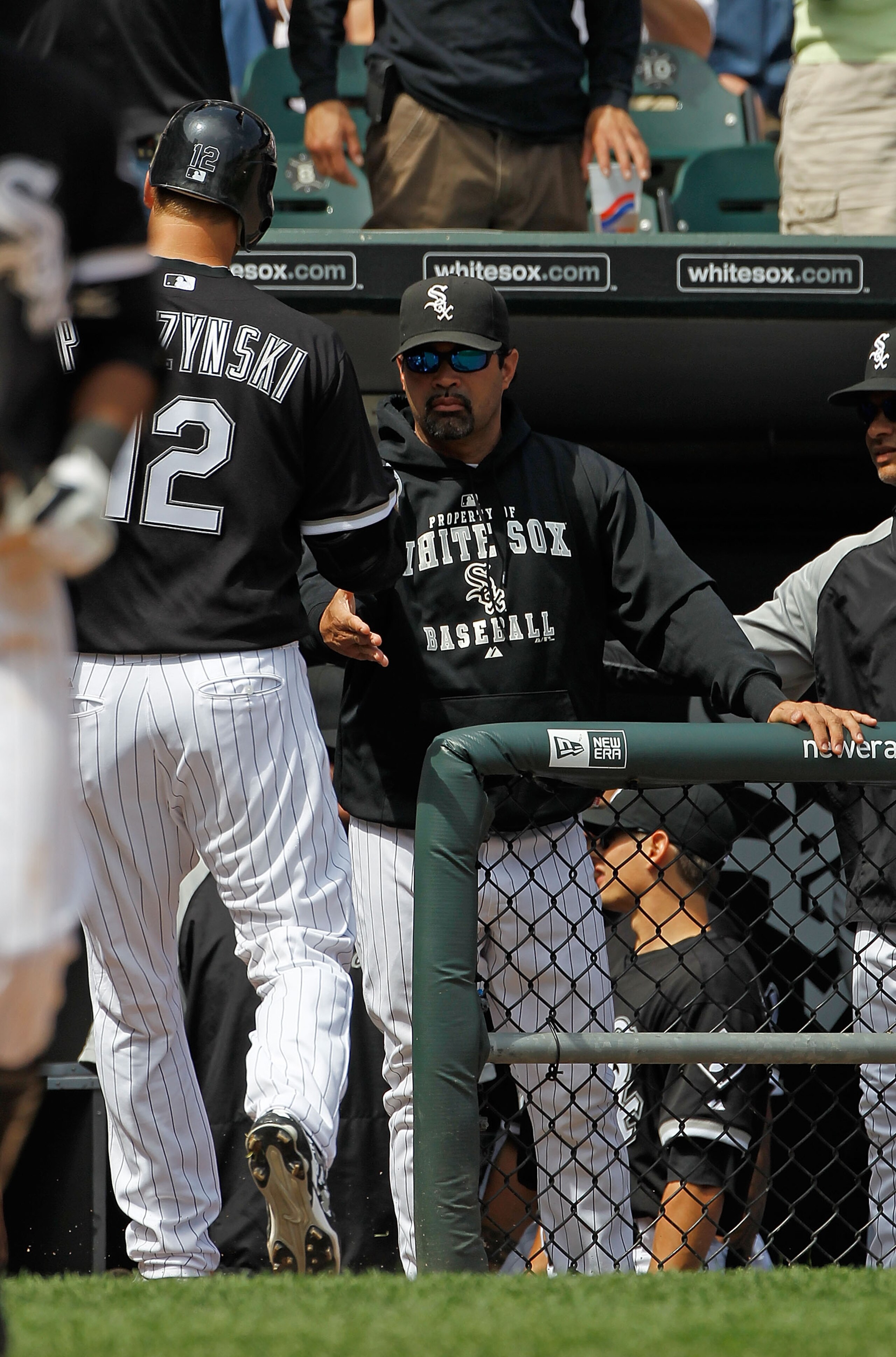 CHICAGO - JUNE 10: Manager Ozzie Guillen #13 of the Chicago White Sox congrautlates A.J. Perizynski #12 during a game against the Detriot Tigers at U.S. Cellular Field on June 10, 2010 in Chicago, Illinois. The White Sox defeated the Tigers 3-0. (Photo by