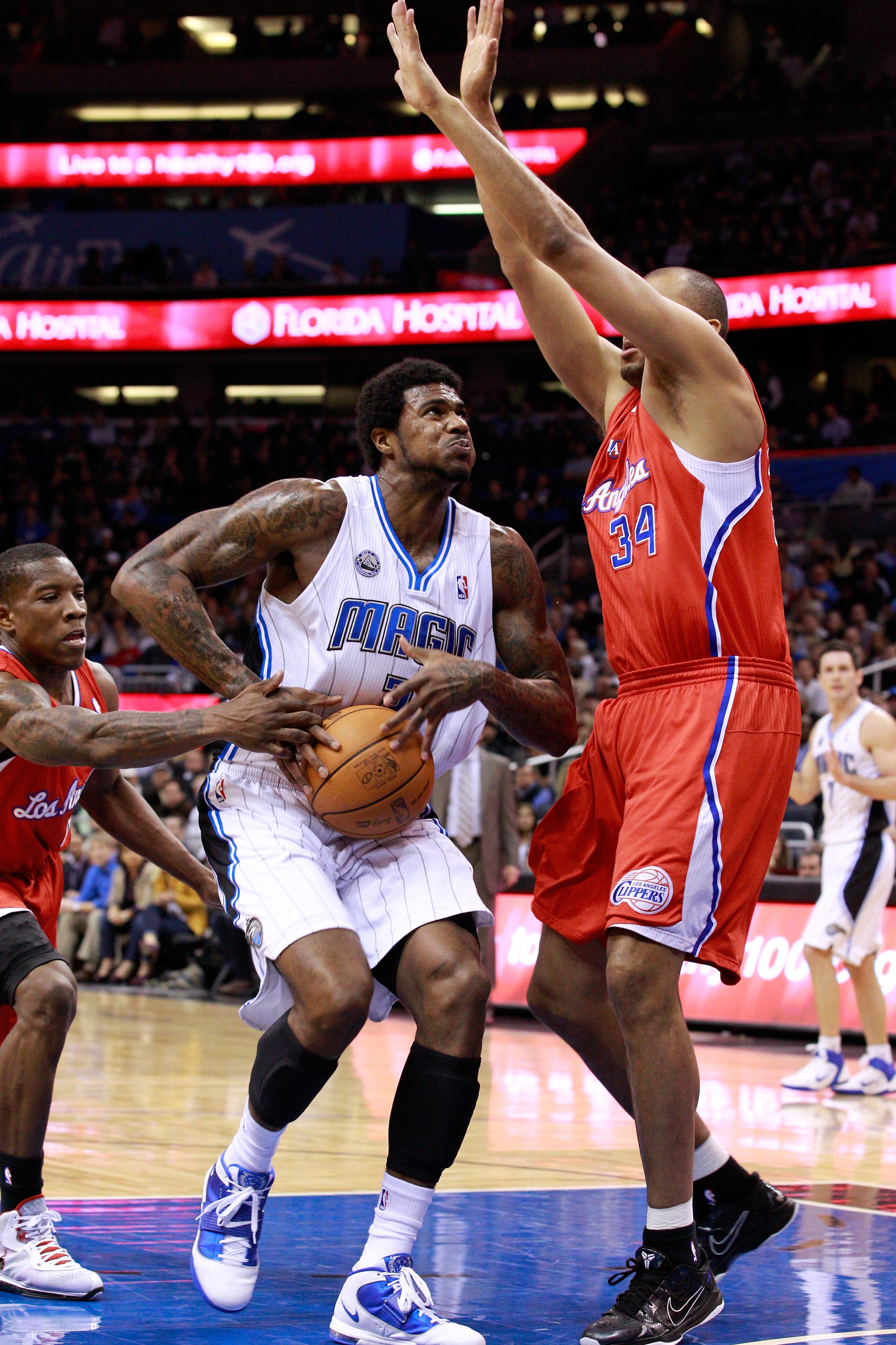 ORLANDO, FL - FEBRUARY 08:  Earl Clark #3 of the Orlando Magic attempts a shot against Brian Cook #34 of the Los Angeles Clippers during the game at Amway Arena on February 8, 2011 in Orlando, Florida.  NOTE TO USER: User expressly acknowledges and agrees