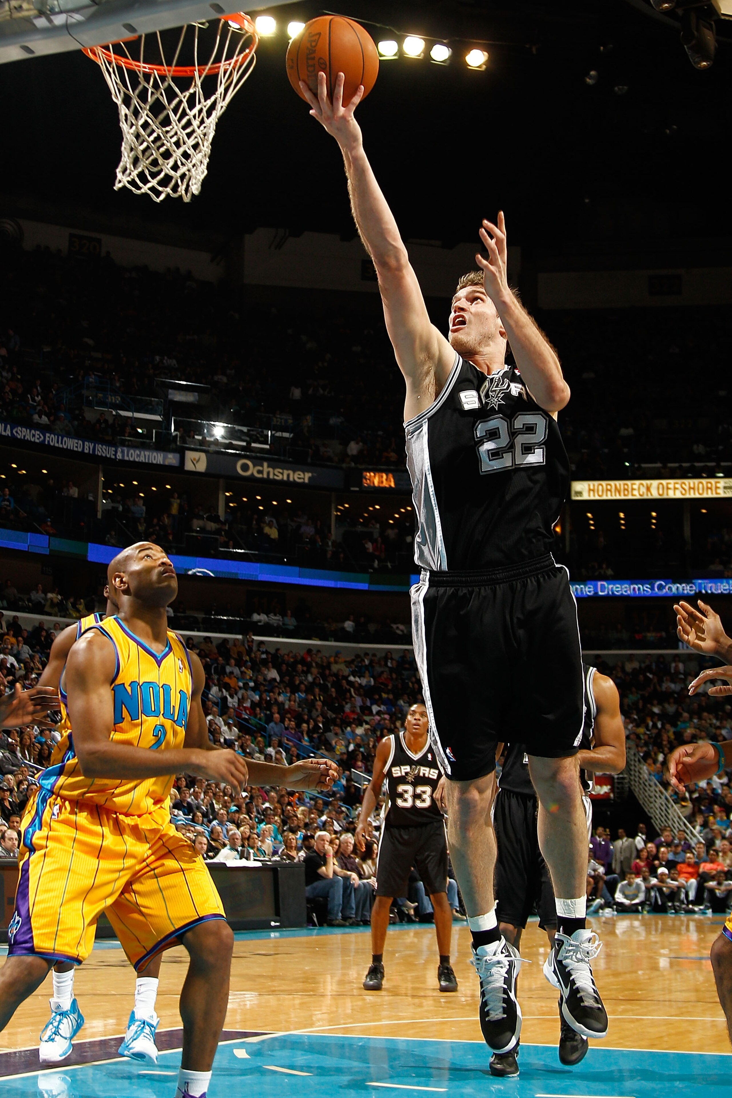 NEW ORLEANS, LA - JANUARY 22:  Tiago Splitter #22 of the San Antonio Spurs shoots the ball over Jarrett Jack #2 of the New Orleans Hornets at the New Orleans Arena on January 22, 2011 in New Orleans, Louisiana.  The Hornets defeated the Spurs 96-72.  NOTE
