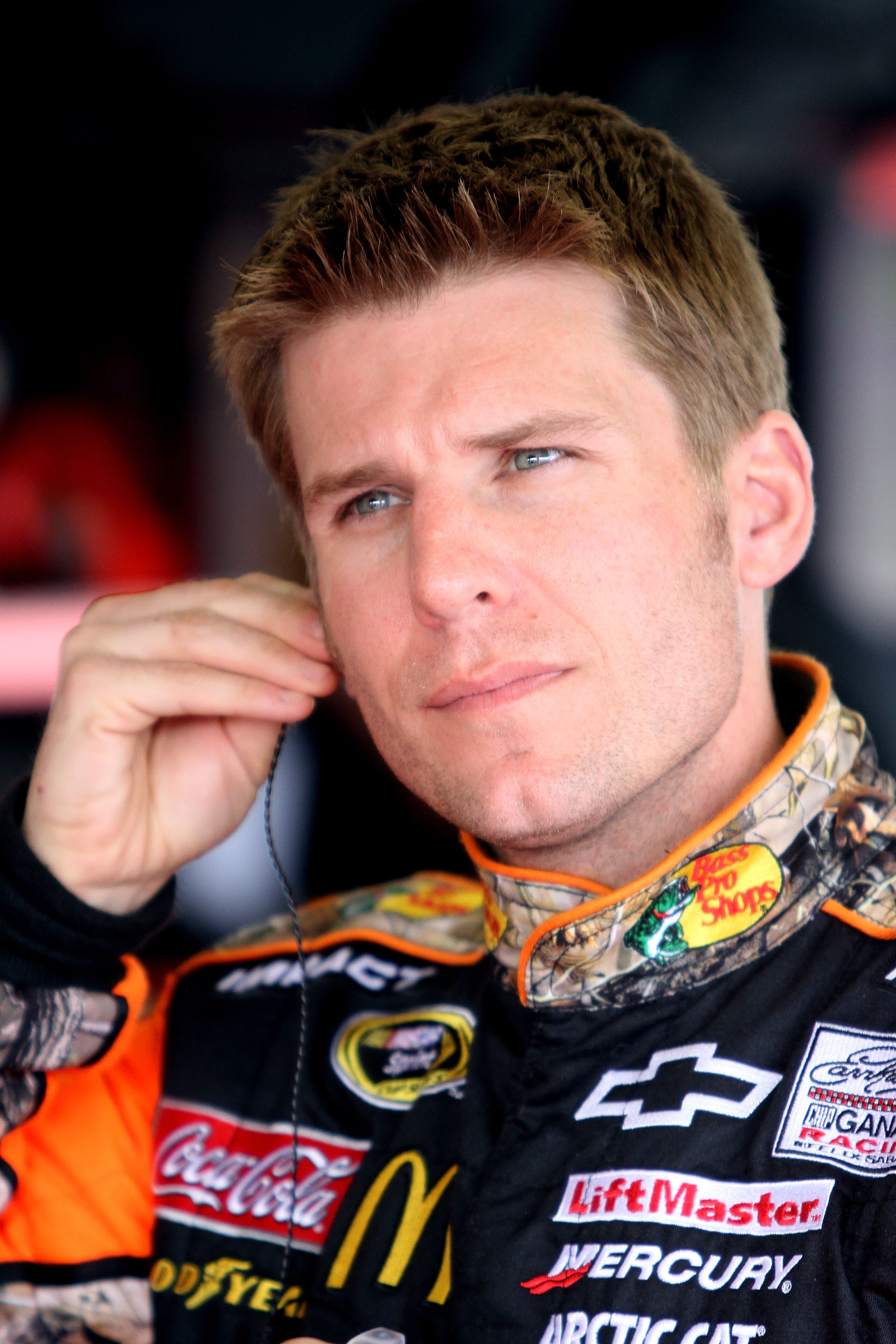 DAYTONA BEACH, FL - FEBRUARY 16:  Jamie McMurray, driver of the #1 Bass Pro Shops Chevrolet, looks on in the garage area during practice for the NASCAR Sprint Cup Series Daytona 500 at Daytona International Speedway on February 16, 2011 in Daytona Beach,