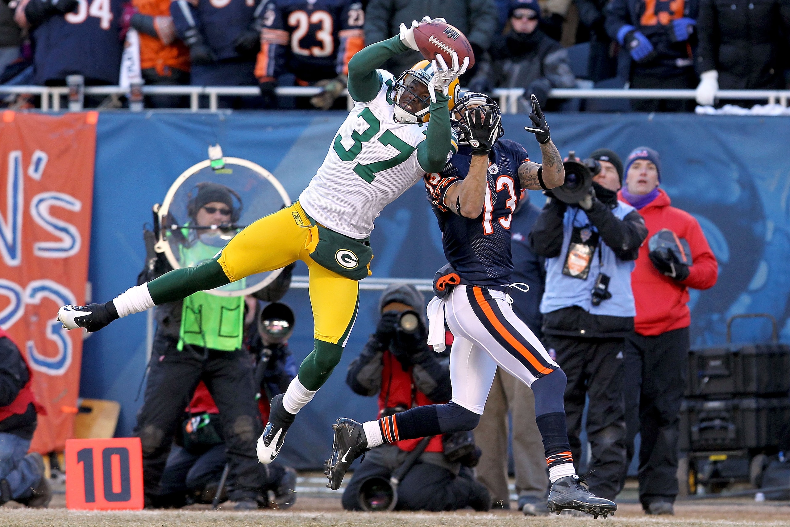 CHICAGO, IL - JANUARY 23: Sam Shields #37 of the Green Bay Packers intercepts a pass intended for Johnny Knox #13 of the Chicago Bears late in the second quarter in the NFC Championship Game at Soldier Field on January 23, 2011 in Chicago, Illinois. (Ph CHICAGO, IL - JANUARY 23: Sam Shields #37 of the Green Bay Packers intercepts a pass intended for Johnny Knox #13 of the Chicago Bears late in the second quarter in the NFC Championship Game at Soldier Field on January 23, 2011 in Chicago, Illinois. (Ph
