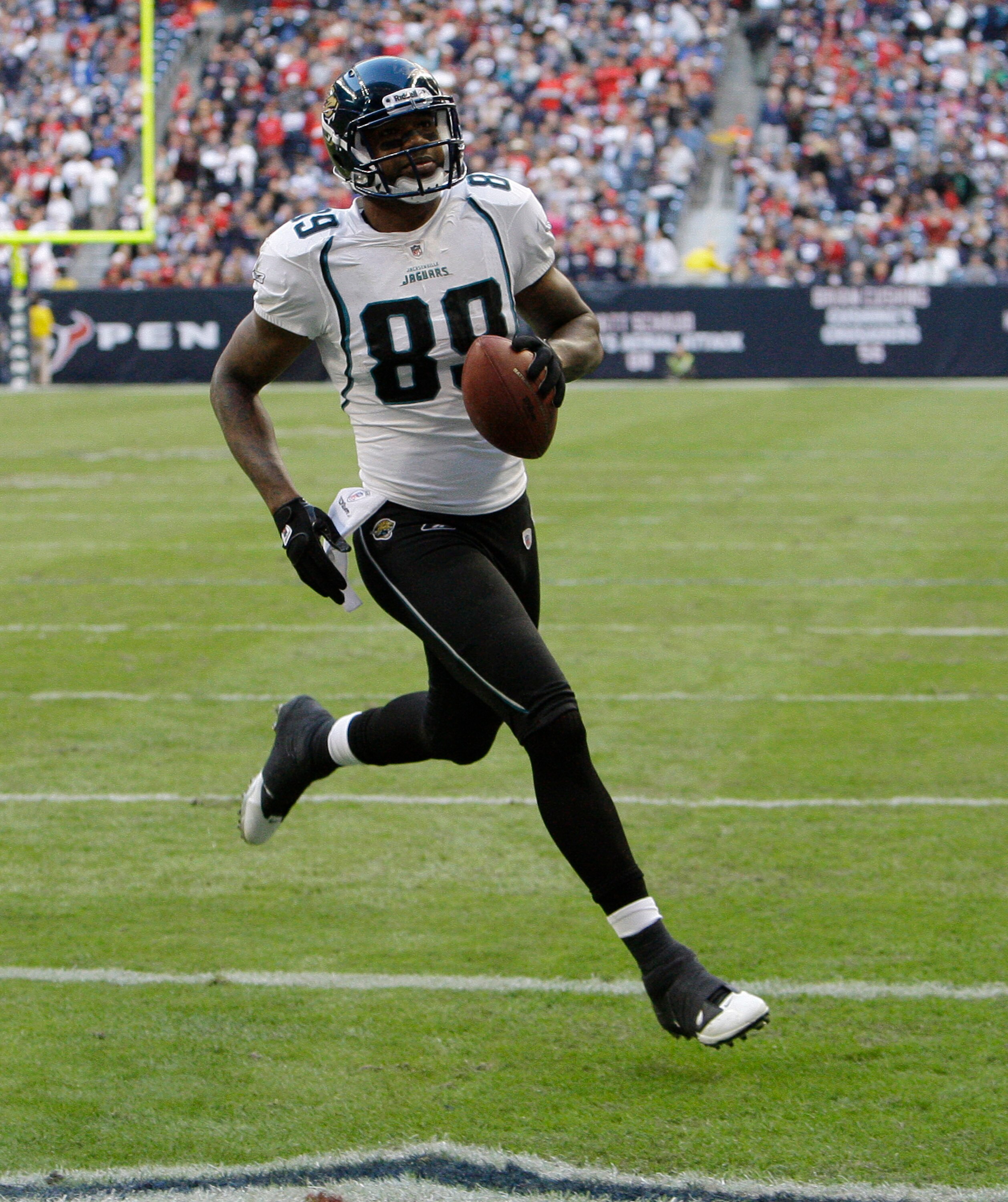 HOUSTON - JANUARY 02:  Wide receiver Mike Thomas #80 of the Jacksonville Jaguars scores in the second quarter against the Houston Texans at Reliant Stadium on January 2, 2011 in Houston, Texas.  (Photo by Bob Levey/Getty Images)
