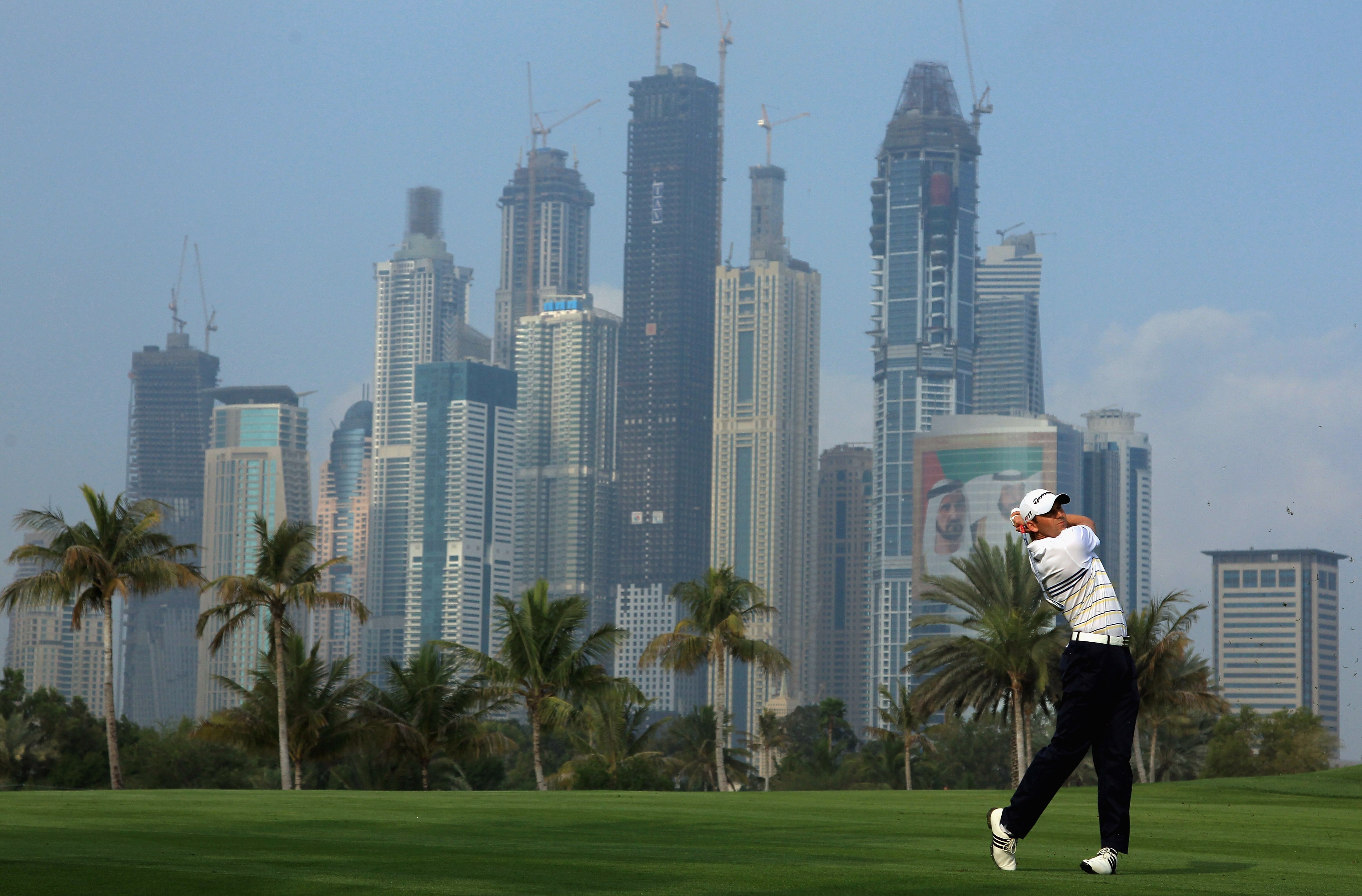 DUBAI, UNITED ARAB EMIRATES - FEBRUARY 10:  Sergio Garcia of Spain plays his second shot on the 13th hole during the first round of the Omega Dubai Desert Classic on the Majlis course at the Emirates Golf Club on February 10, 2011 in Dubai, United Arab Em