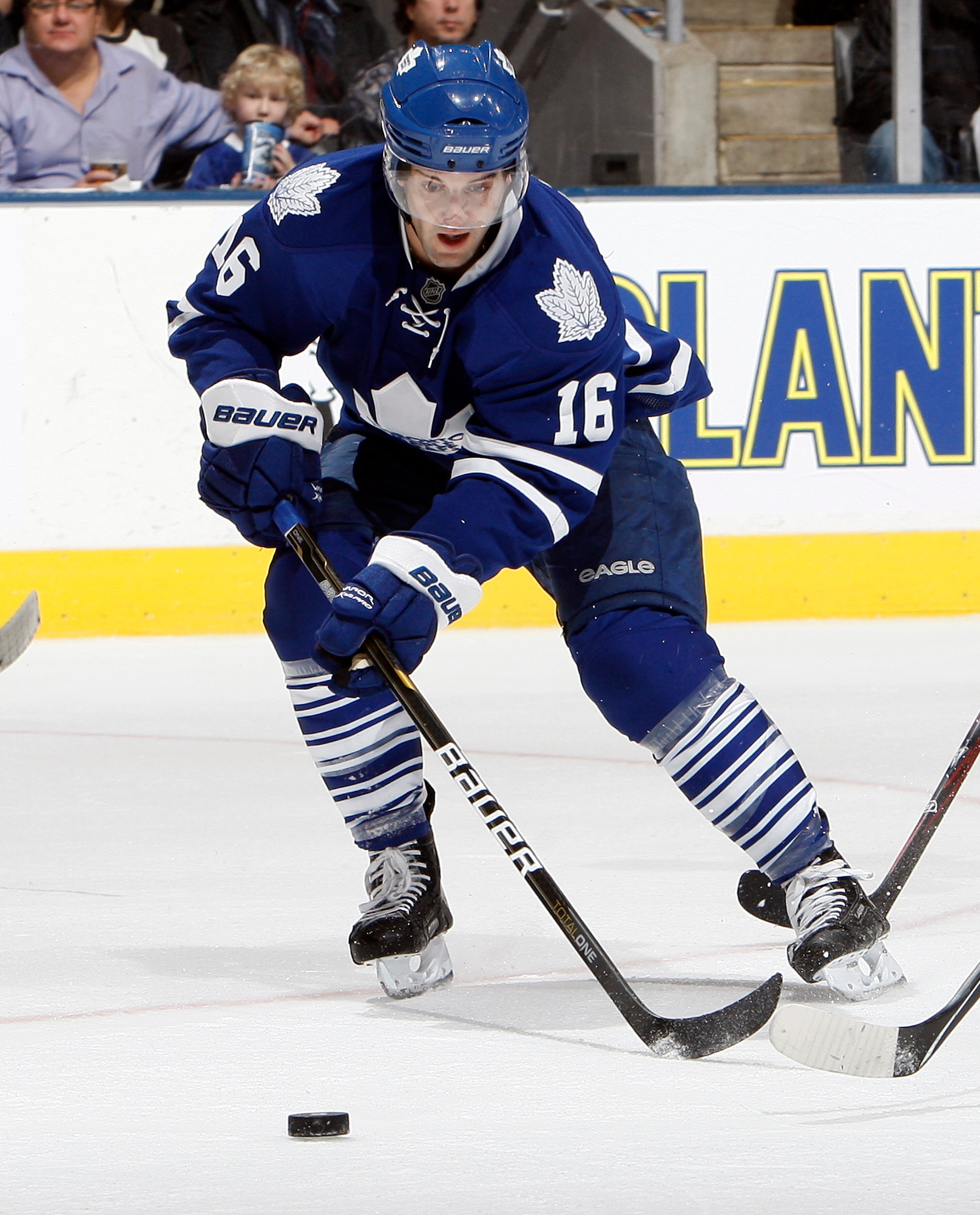 TORONTO, CANADA - JANUARY 22:  Clarke MacArthur #16 of the Toronto Maple Leafs grabs a loose puck during game action at the Air Canada Centre against the Washington Capitals January 22, 2011 in Toronto, Ontario, Canada. (Photo by Abelimages/Getty Images)