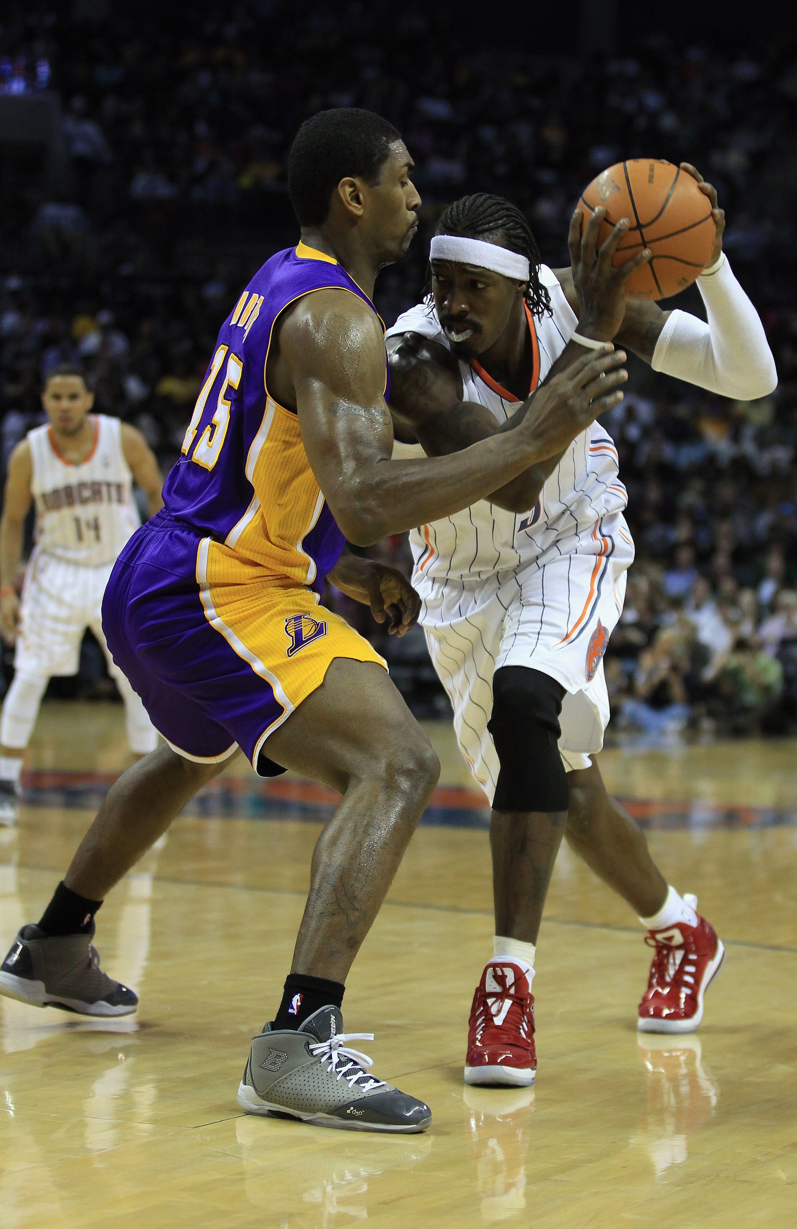 CHARLOTTE, NC - FEBRUARY 14:  Ron Artest #15 of the Los Angeles Lakers defends Gerald Wallace #3 of the Charlotte Bobcats during their game at Time Warner Cable Arena on February 14, 2011 in Charlotte, North Carolina. NOTE TO USER: User expressly acknowle