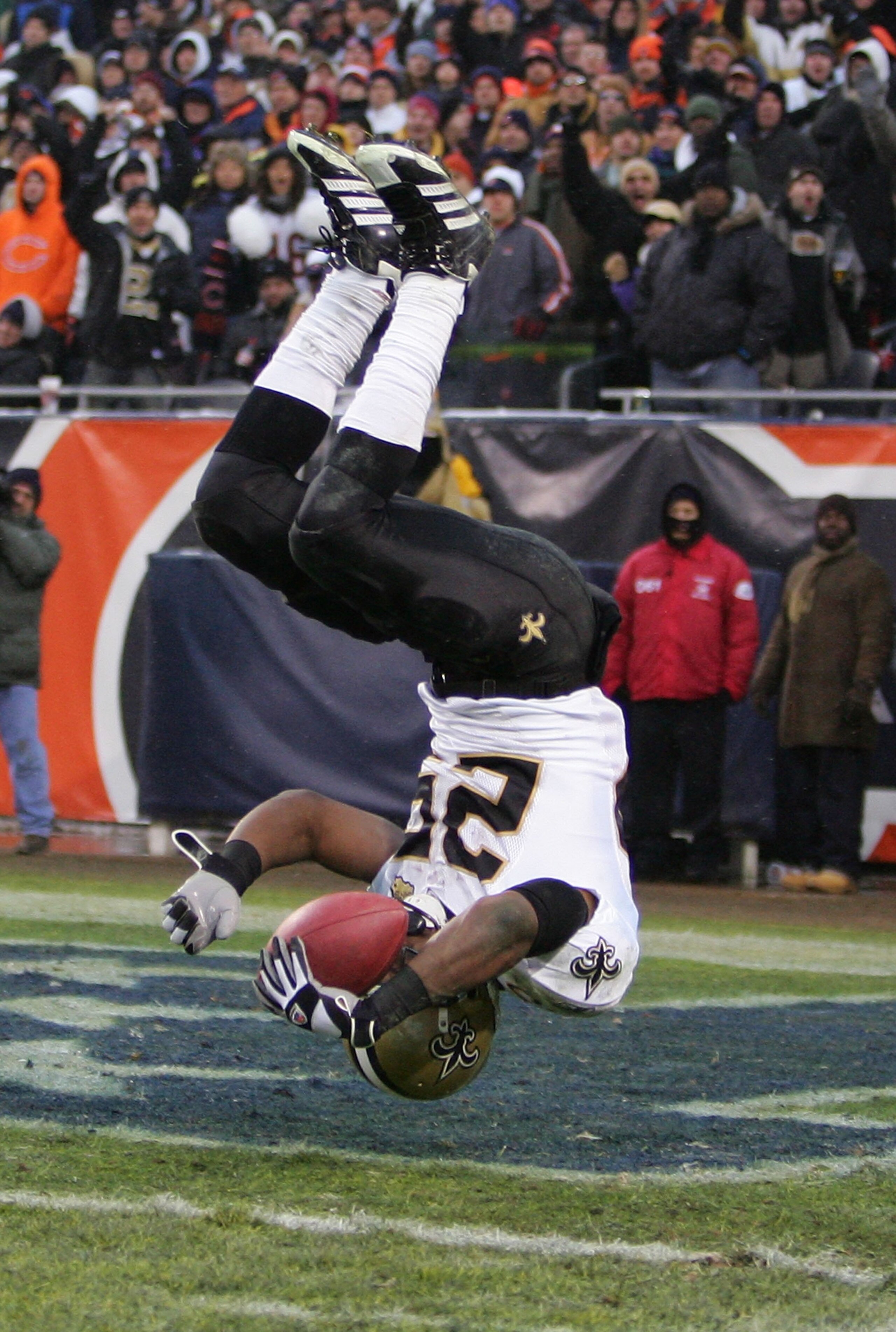 CHICAGO - JANUARY 21: Reggie Bush #25 of the New Orleans Saints flips into the endzone on an 88-yard touchdown reception in the third quarter against the Chicago Bears during the NFC Championship Game January 21, 2007 at Soldier Field in Chicago, Illinoi CHICAGO - JANUARY 21: Reggie Bush #25 of the New Orleans Saints flips into the endzone on an 88-yard touchdown reception in the third quarter against the Chicago Bears during the NFC Championship Game January 21, 2007 at Soldier Field in Chicago, Illinoi