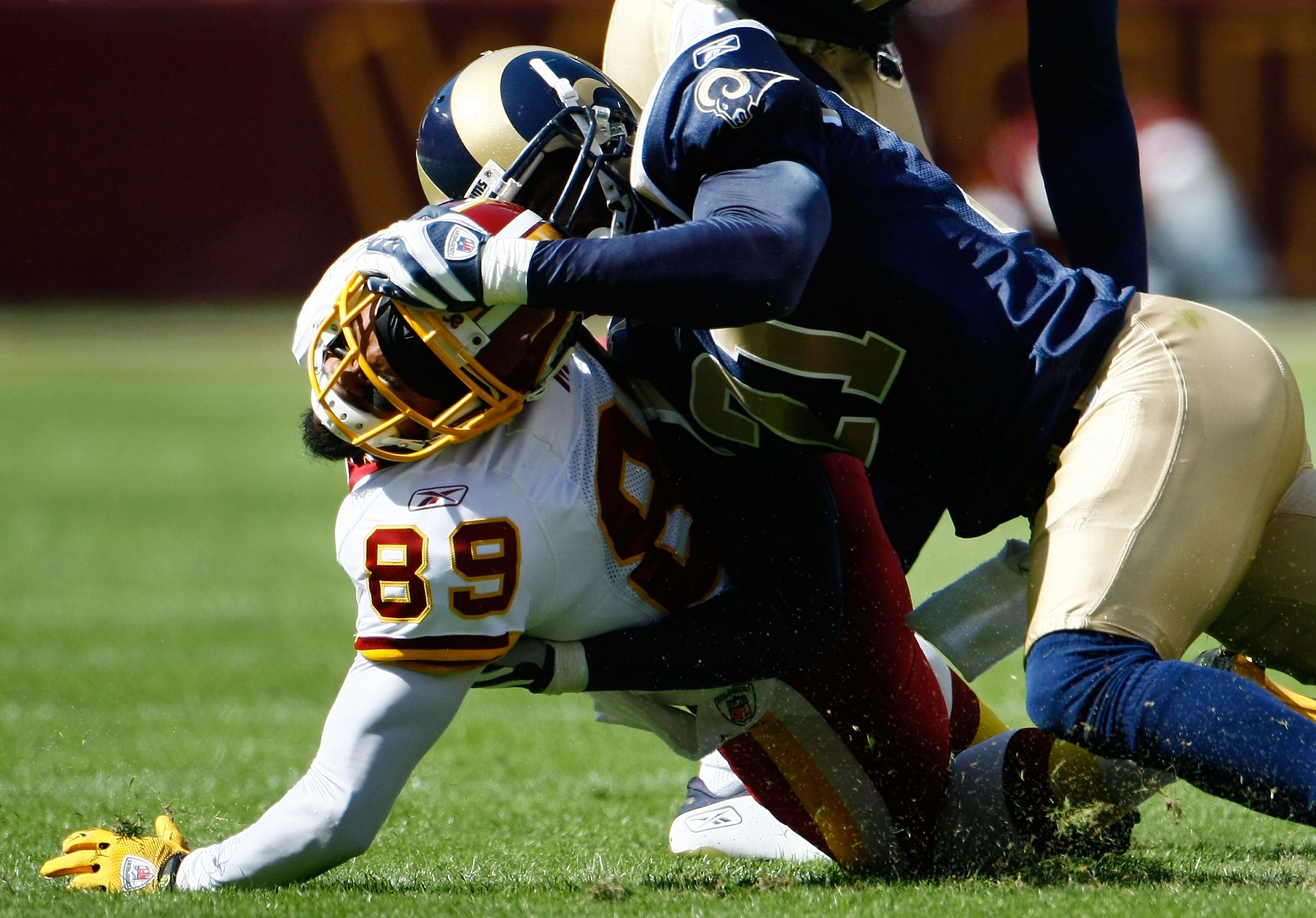 LANDOVER, MD - SEPTEMBER 20:  Santana Moss #89 of the Washington Redskins is tackled, and then fumbled, following a tackle by Oshiomogho Atogwe #21 of the St. Louis Rams  during their game on September 20, 2009 at FedEx Field in Landover, Maryland.  (Phot