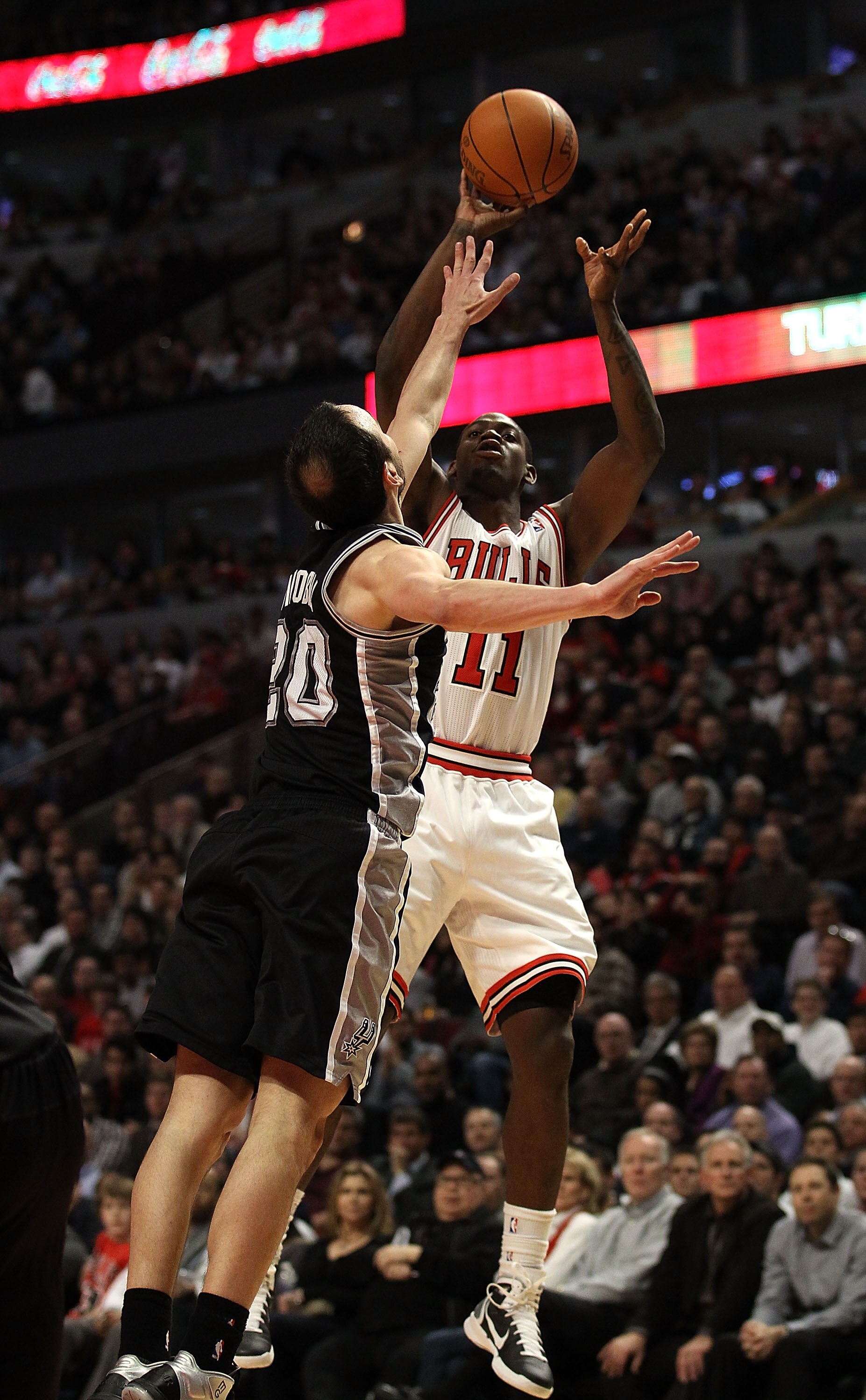 CHICAGO, IL - FEBRUARY 17: Ronnie Brewer #11 of the Chicago Bulls puts up a shot over Manu Ginobili #20 of the San Antonio Spurs at the United Center on February 17, 2011 in Chicago, Illinois. The Bulls defeated the Spurs 109-99. NOTE TO USER: User expres
