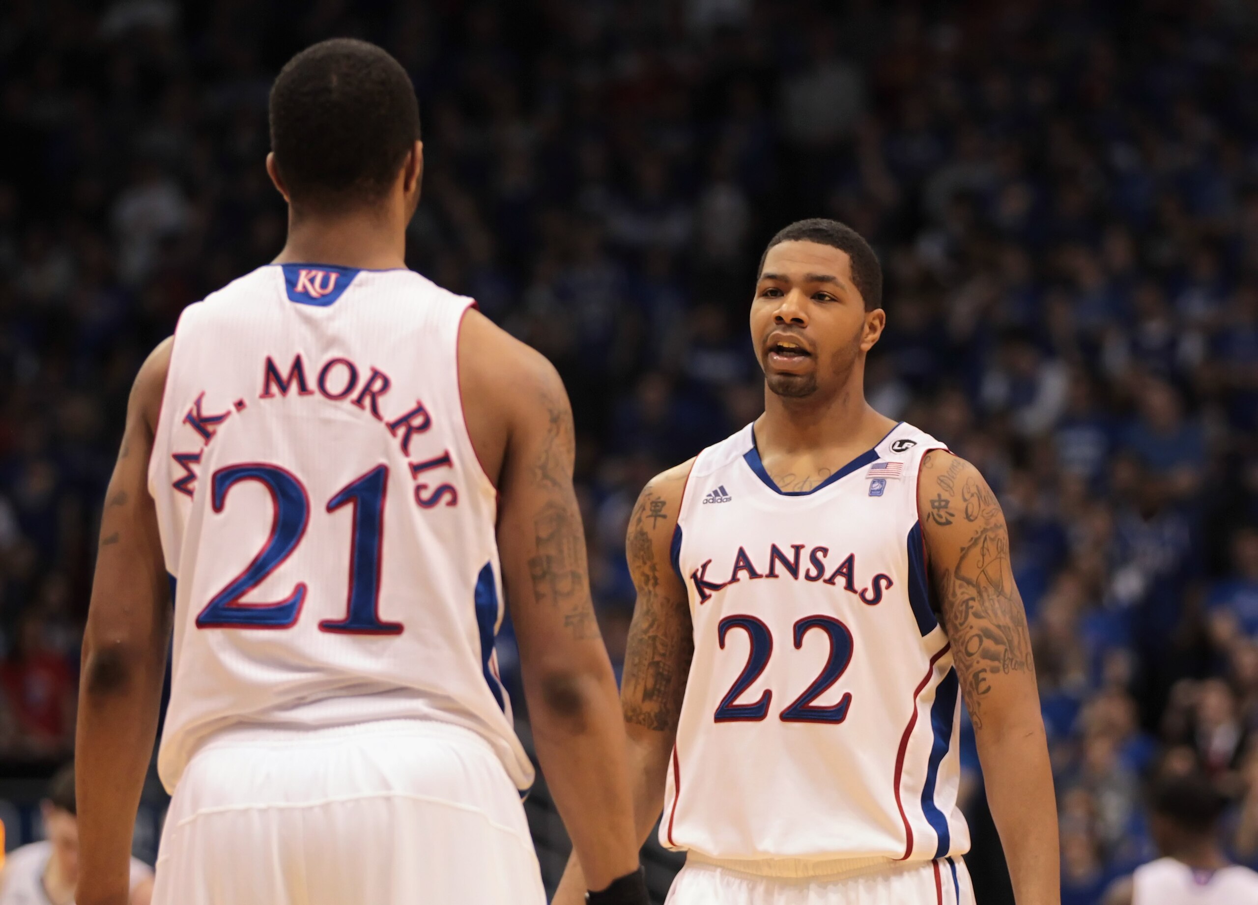 LAWRENCE, KS - FEBRUARY 12: Marcus Morris #22 of the Kansas Jayhawks talks with his brother Markieff Morris #21 during the game against the Iowa State Cyclones on February 12, 2011 at Allen Fieldhouse in Lawrence, Kansas. (Photo by Jamie Squire/Getty Im LAWRENCE, KS - FEBRUARY 12: Marcus Morris #22 of the Kansas Jayhawks talks with his brother Markieff Morris #21 during the game against the Iowa State Cyclones on February 12, 2011 at Allen Fieldhouse in Lawrence, Kansas. (Photo by Jamie Squire/Getty Im