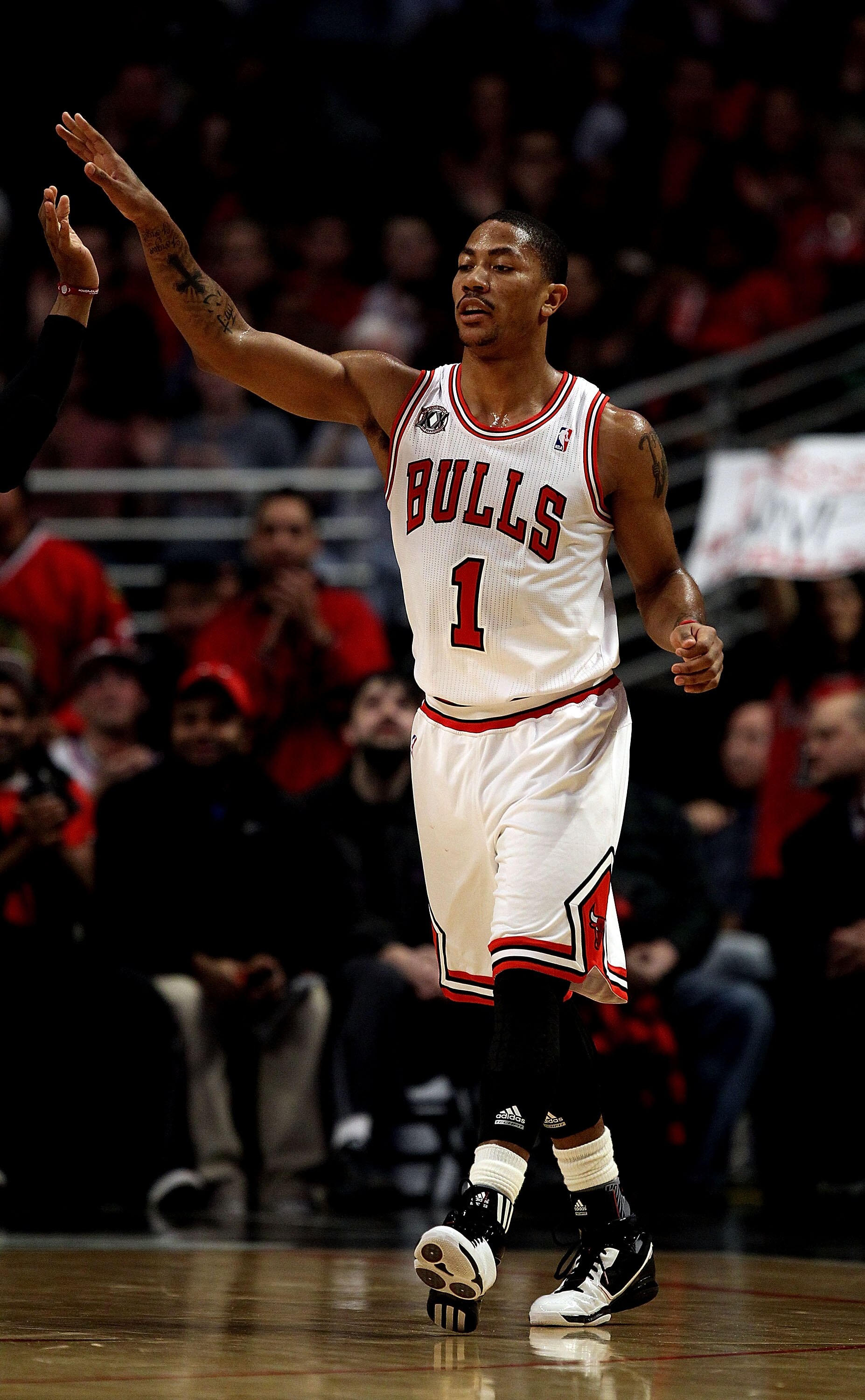 CHICAGO, IL - FEBRUARY 17: Derrick Rose #1 of the Chicago Bulls celebrates with a teammate during a game against the San Antonio Spurs at the United Center on February 17, 2011 in Chicago, Illinois. The Bulls defeated the Spurs 109-99. NOTE TO USER: User