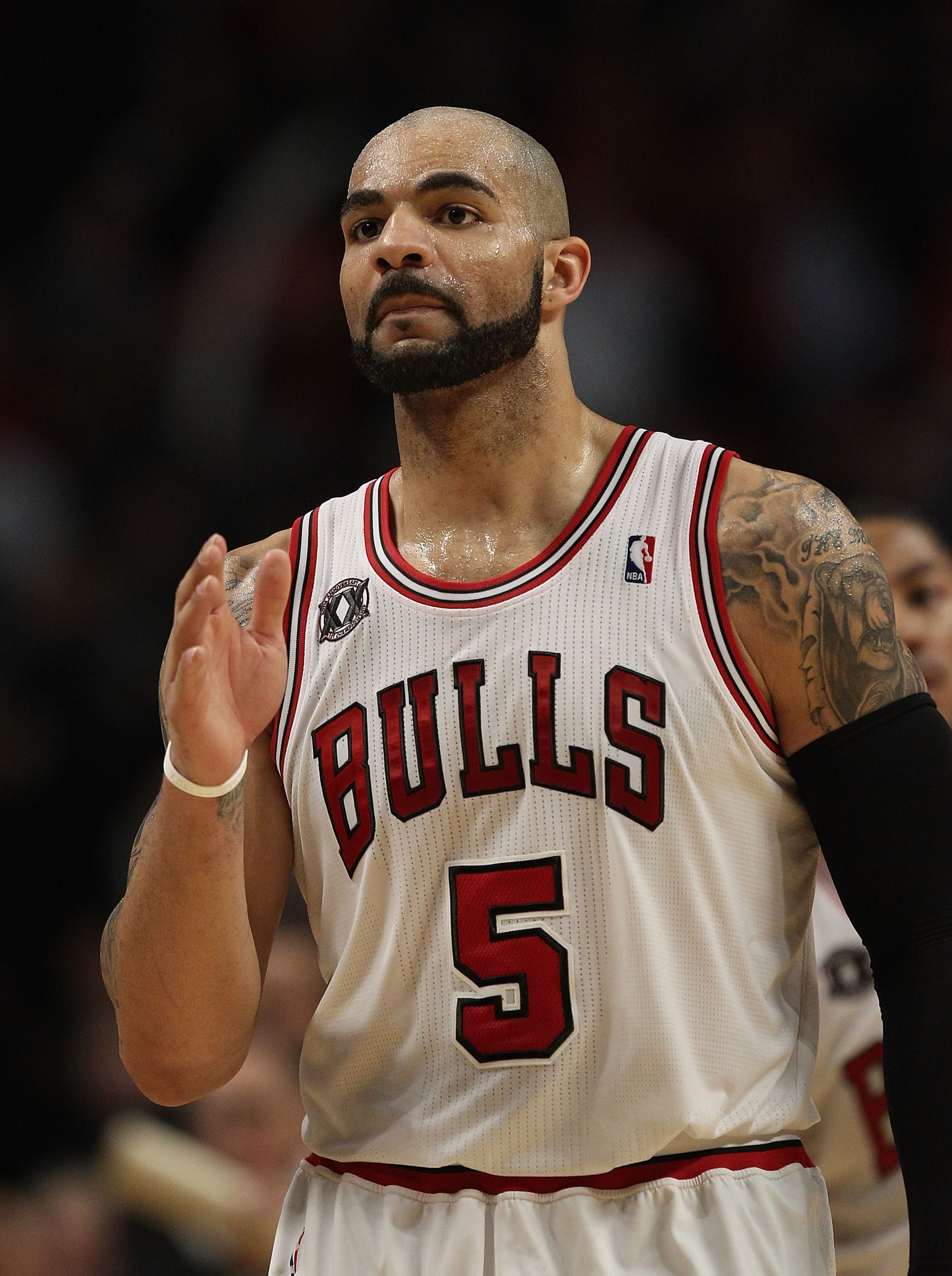 CHICAGO, IL - FEBRUARY 17: Carlos Boozer #5 of the Chicago Bulls waves to members of the San Antonio Spurs after a win at the United Center on February 17, 2011 in Chicago, Illinois. The Bulls defeated the Spurs 109-99. NOTE TO USER: User expressly acknow CHICAGO, IL - FEBRUARY 17: Carlos Boozer #5 of the Chicago Bulls waves to members of the San Antonio Spurs after a win at the United Center on February 17, 2011 in Chicago, Illinois. The Bulls defeated the Spurs 109-99. NOTE TO USER: User expressly acknow