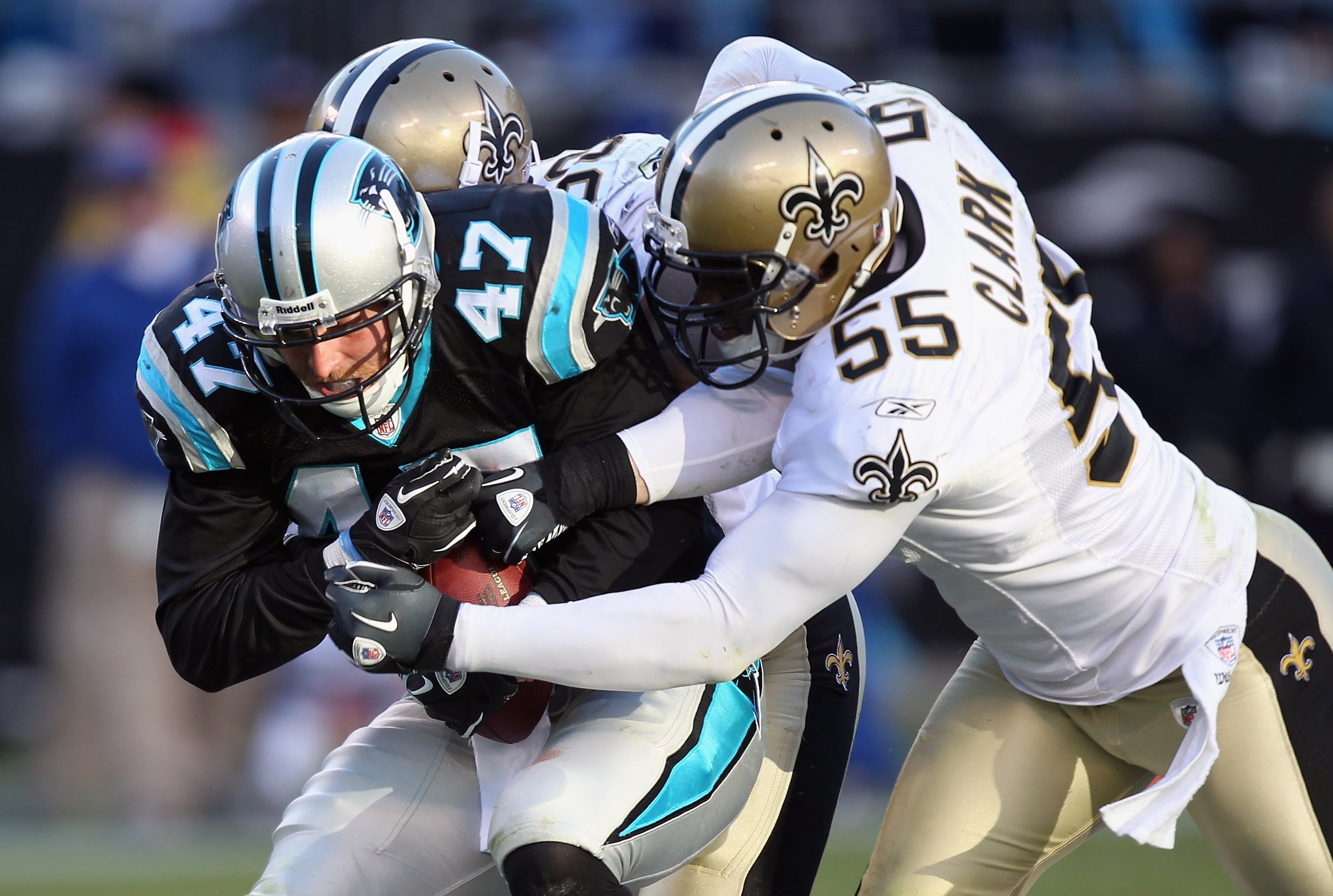 CHARLOTTE, NC - NOVEMBER 07:  Danny Clark #55 of the New Orleans Saints tackles Jeff King #47 of the Carolina Panthers during their game at Bank of America Stadium on November 7, 2010 in Charlotte, North Carolina.  (Photo by Streeter Lecka/Getty Images)