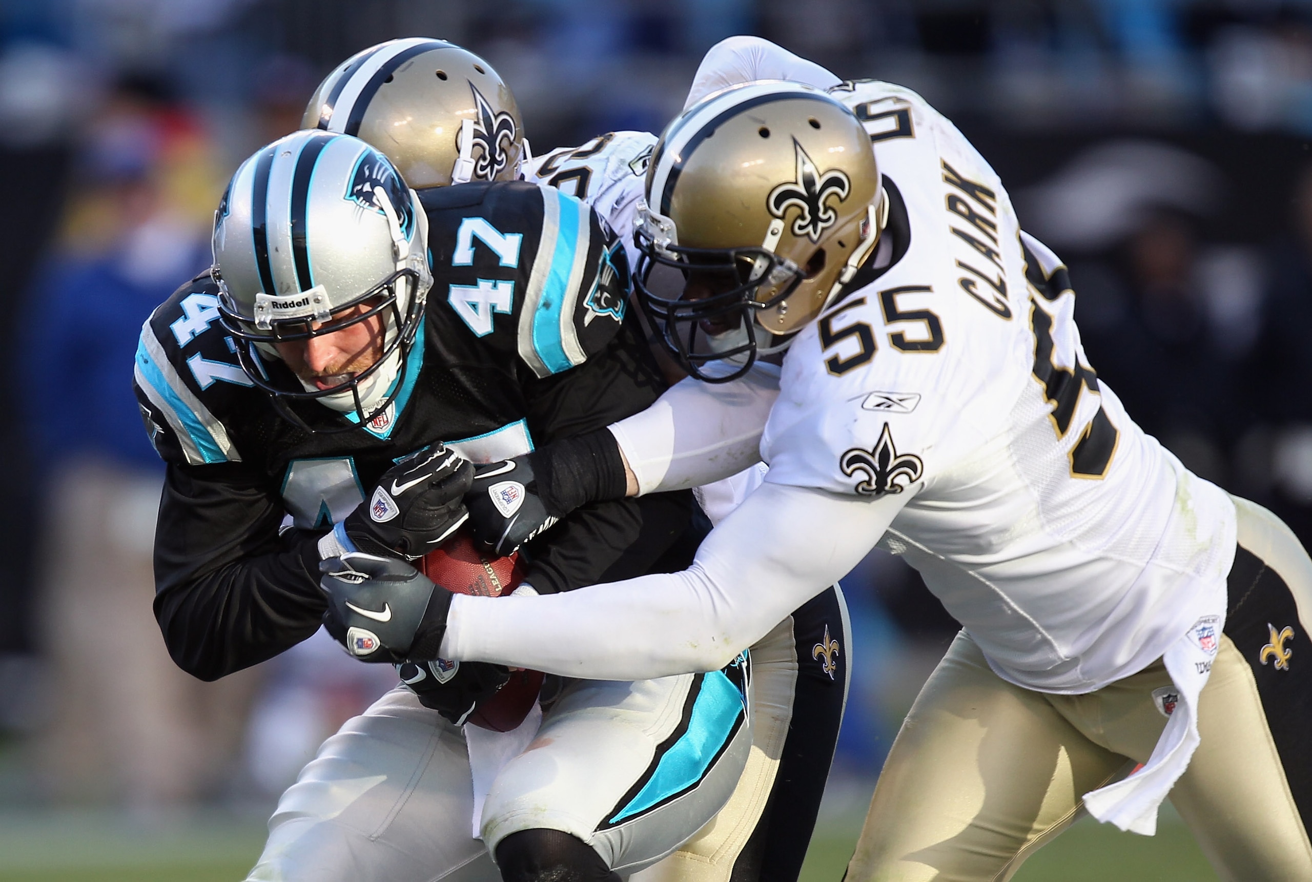 CHARLOTTE, NC - NOVEMBER 07:  Danny Clark #55 of the New Orleans Saints tackles Jeff King #47 of the Carolina Panthers during their game at Bank of America Stadium on November 7, 2010 in Charlotte, North Carolina.  (Photo by Streeter Lecka/Getty Images)